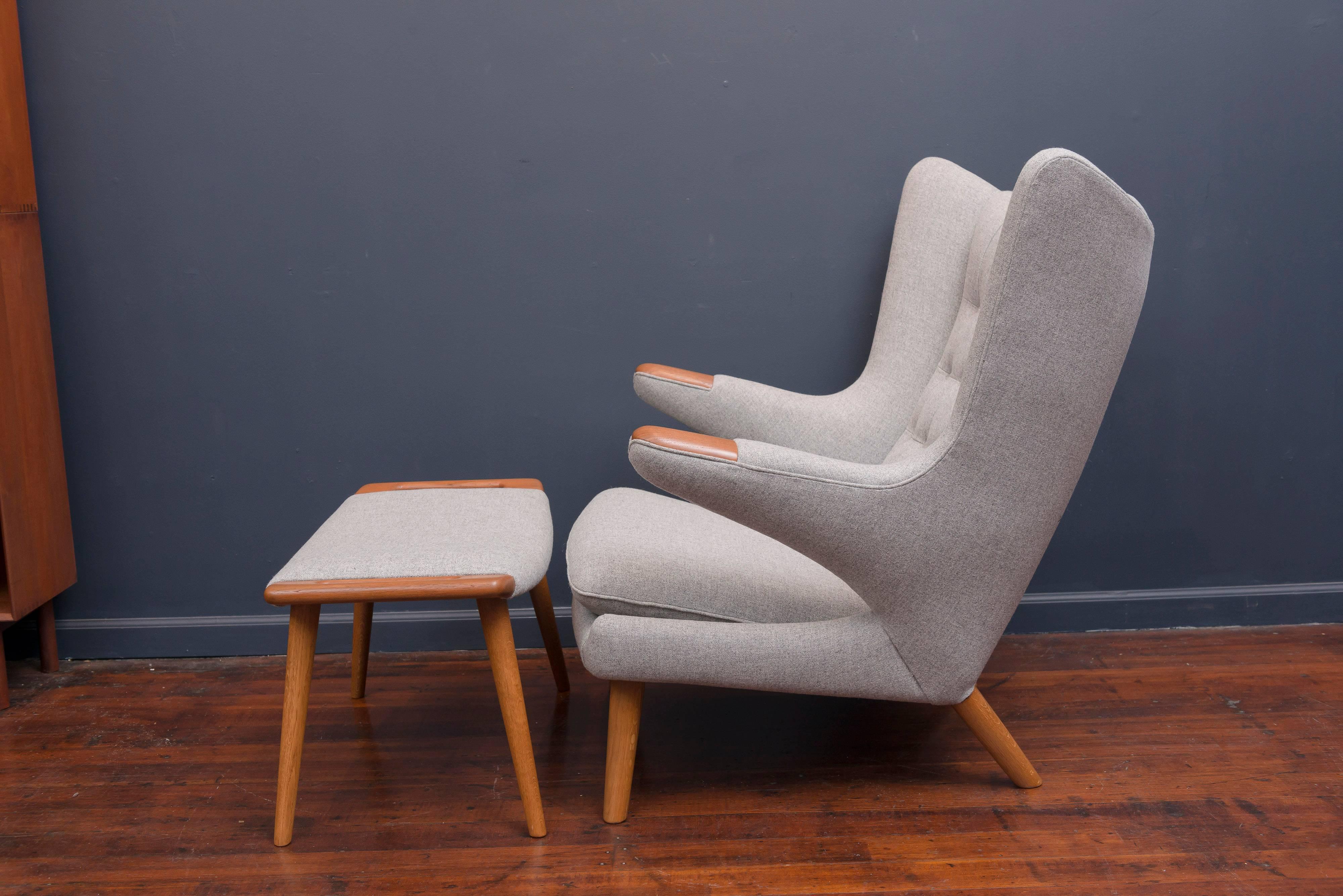 Perfectly restored Hans Wegner papa bear chair and ottoman newly refinished and upholstered in a light grey Danish wool. Simply the most comfortable chair you will ever own.