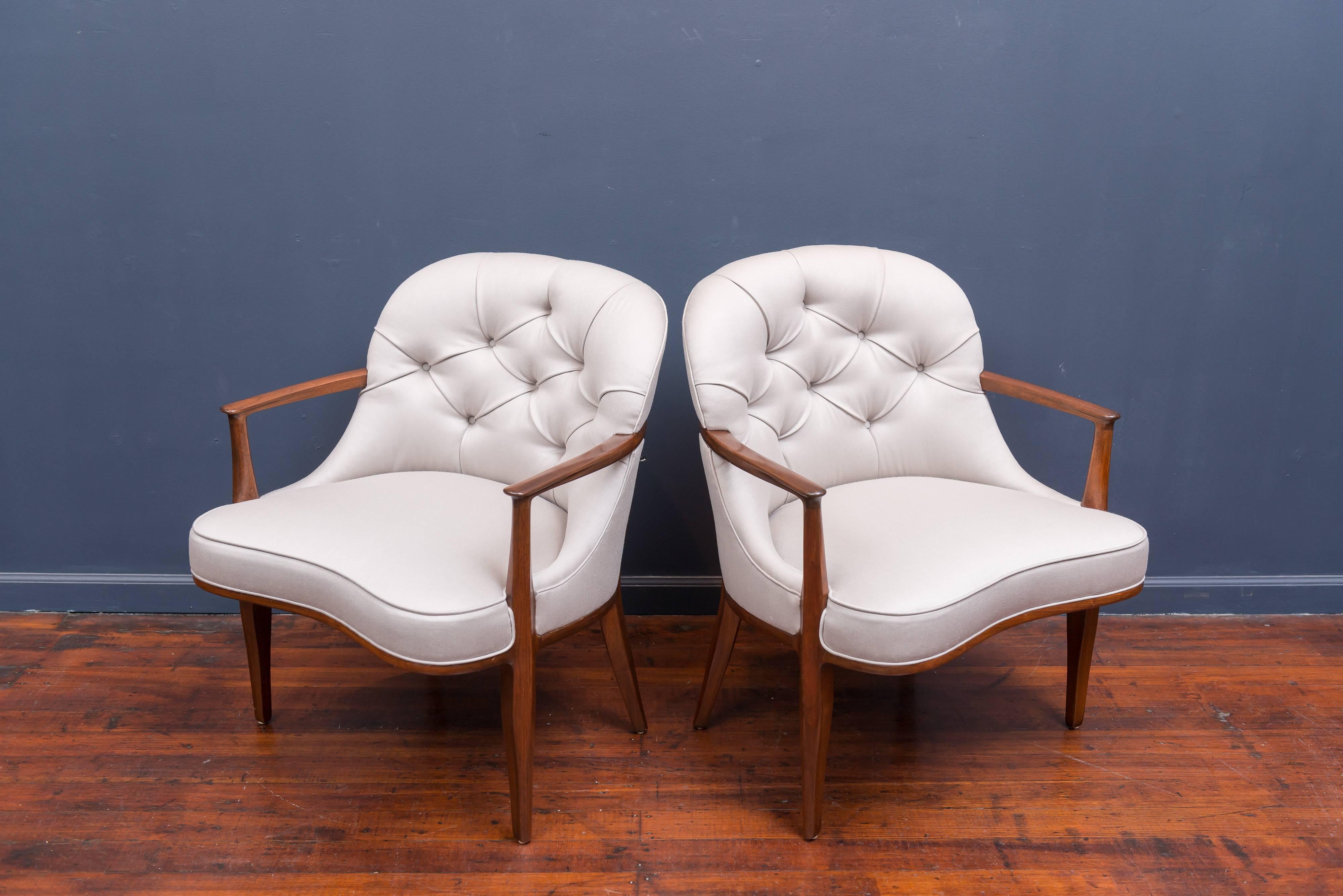 Beautifully restored pair of Janus lounge chairs designed by Edward Wormley for Dunbar. Newly refinished mahogany frames and upholstered in a warm silver satin wool, labeled.