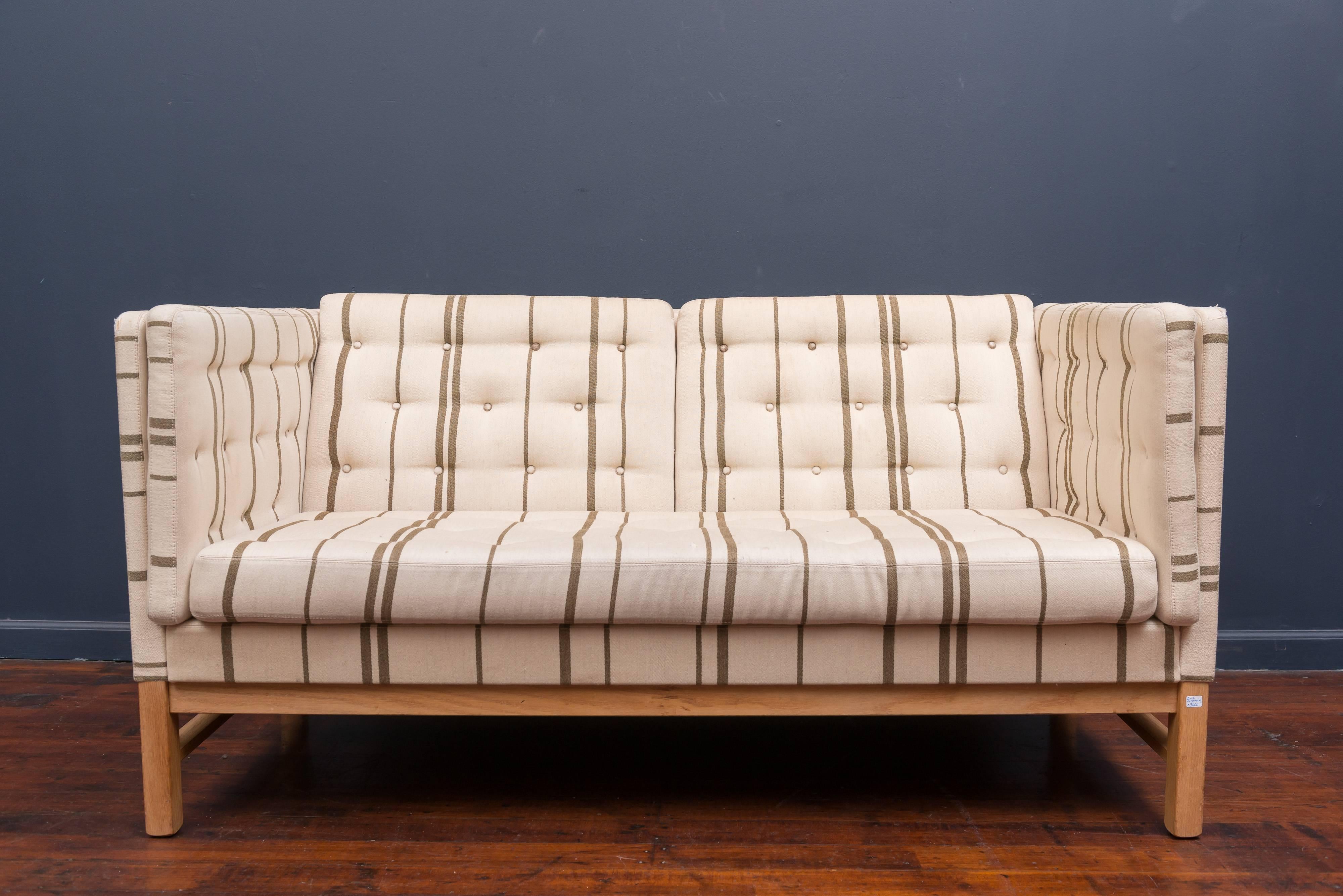Erik Ole Jorgensen design small sofa. High quality love seat or small sofa designed by Erik Ole Jørgensen for Svendborg, Denmark. Oak frame with original vintage upholstery that has been professionally cleaned but shows wear and tear with some