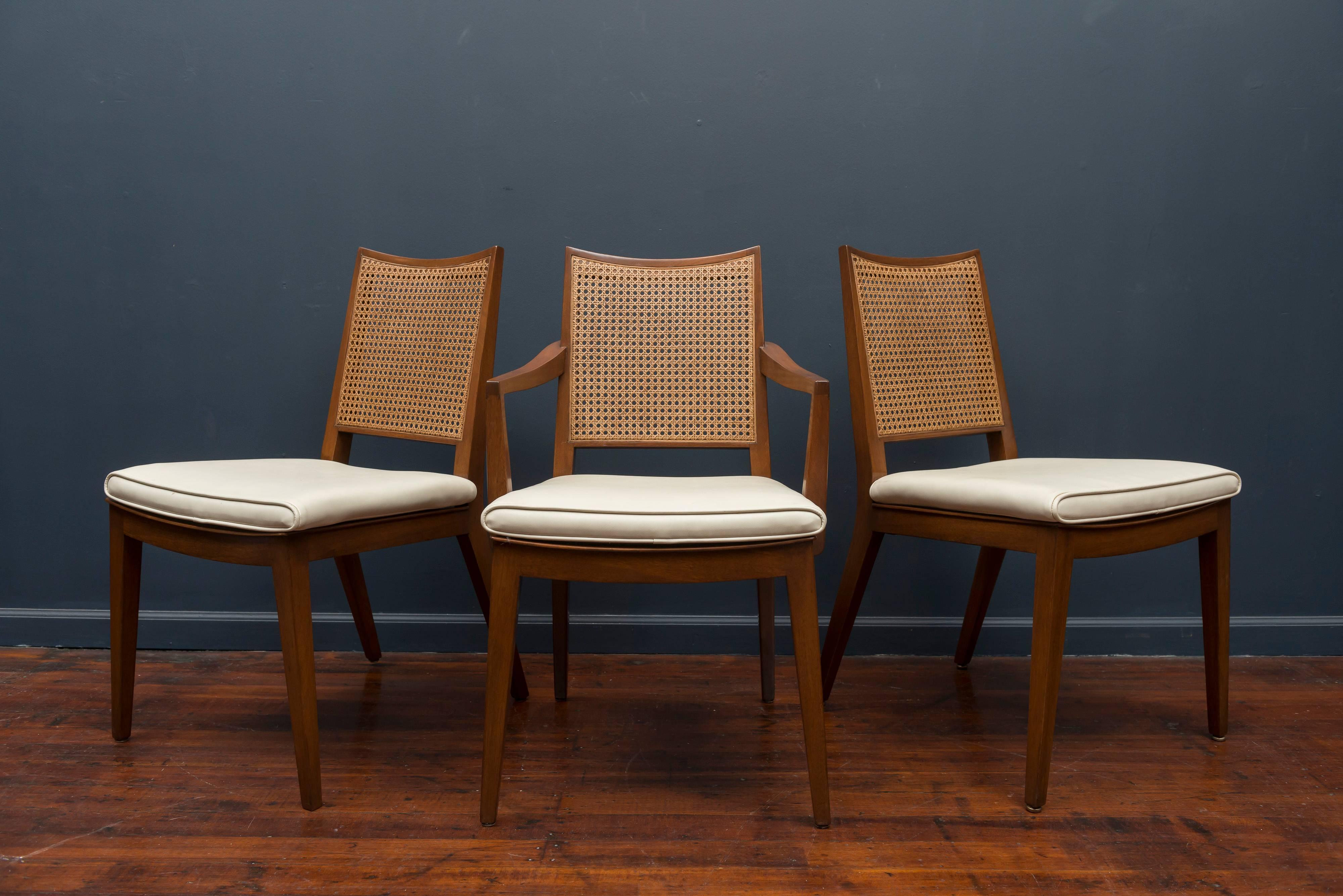 Edward Wormley design for Dunbar set of six mahogany and cane dining chairs, comprising five side and one armchair. Perfectly refinished and newly caned with original seat pads, labeled.