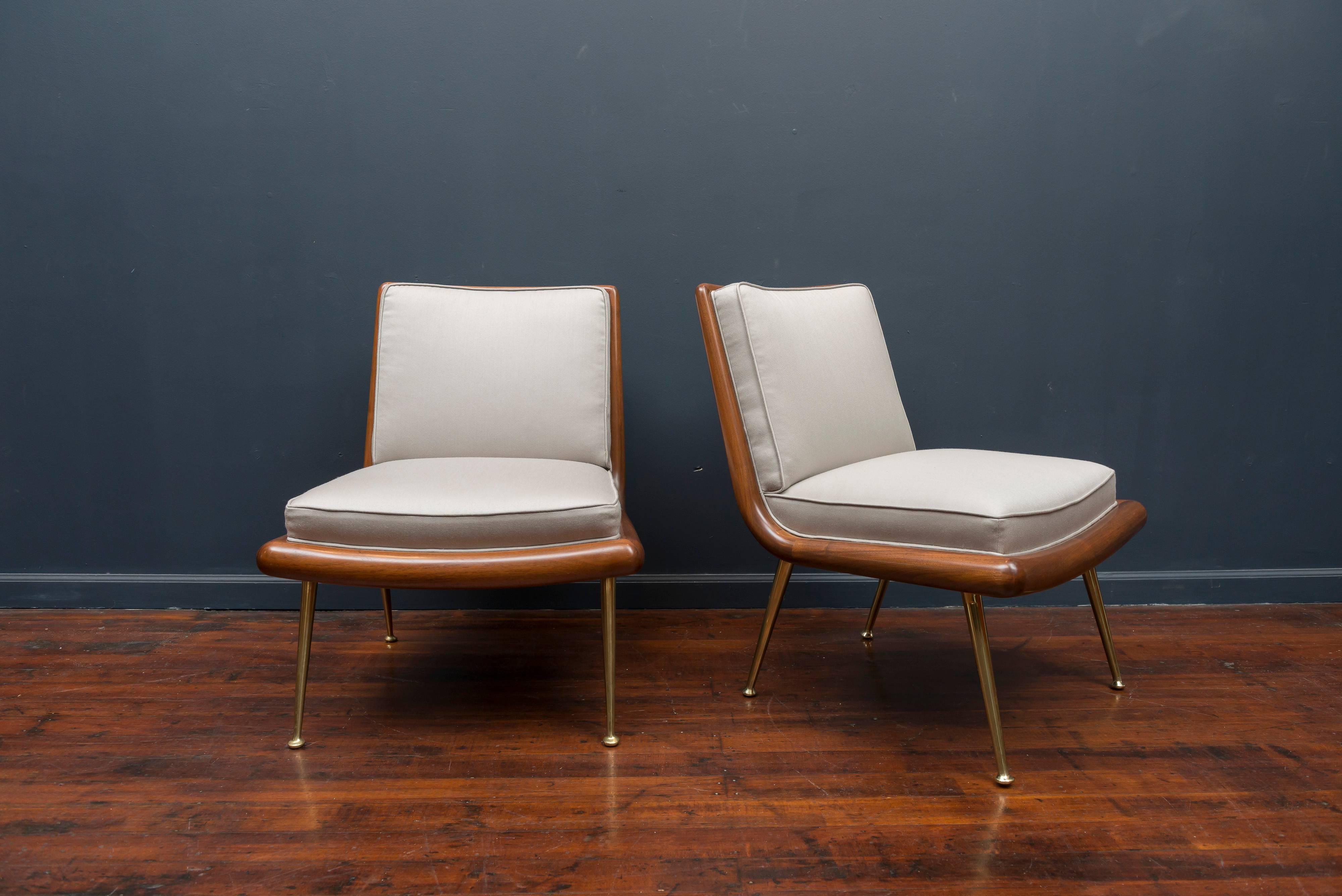 Rare pair of T.H. Robsjohn-Gibbings design lounge chairs for Widdicomb Furniture Co. Newly refinished walnut bull nose frames on polished brass telescoping legs. New light silver Maharam satin wool upholstery.