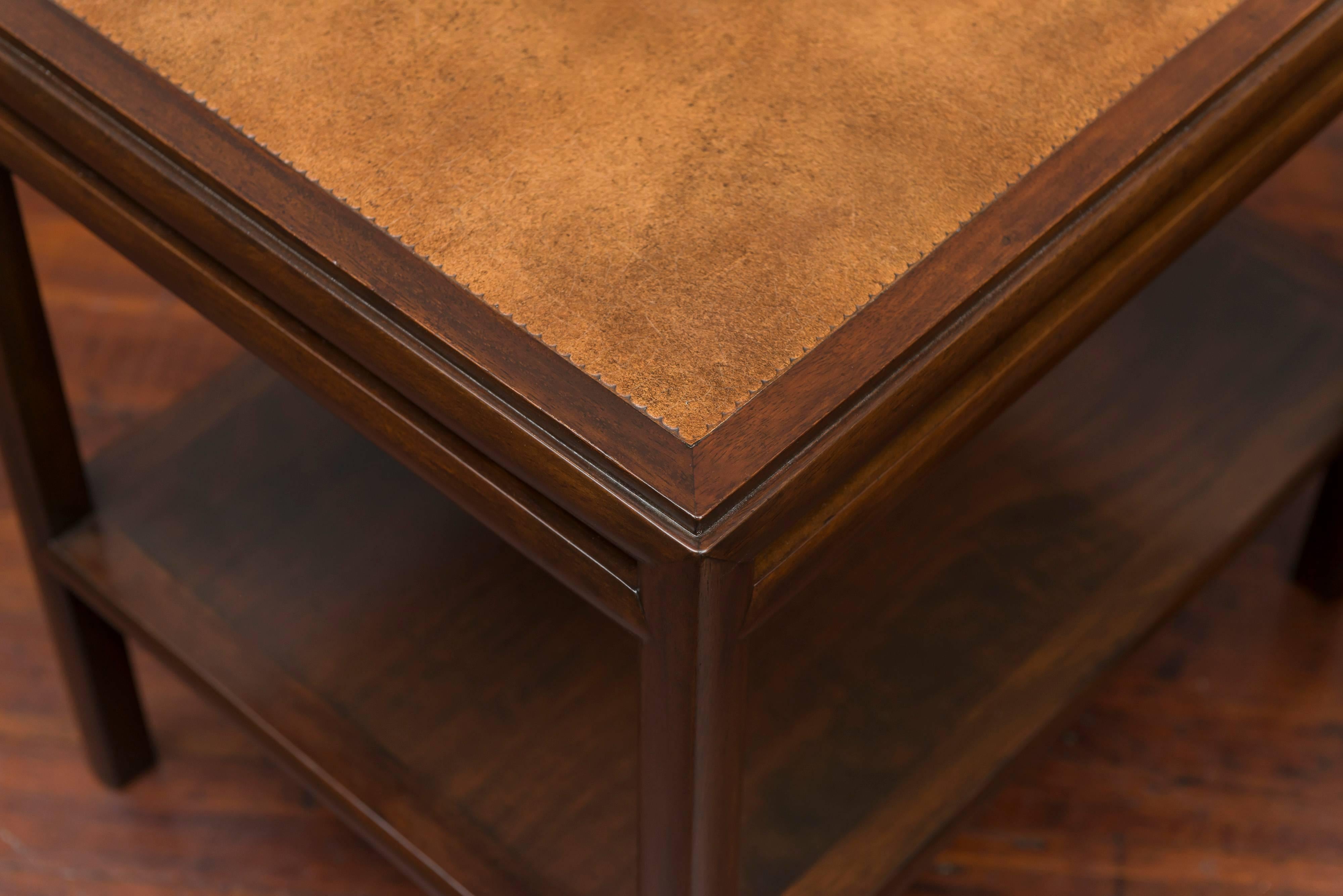 Pair of high quality construction mahogany end tables with embossed leather tops. Perfectly refinished and stamped with the maker's marks.