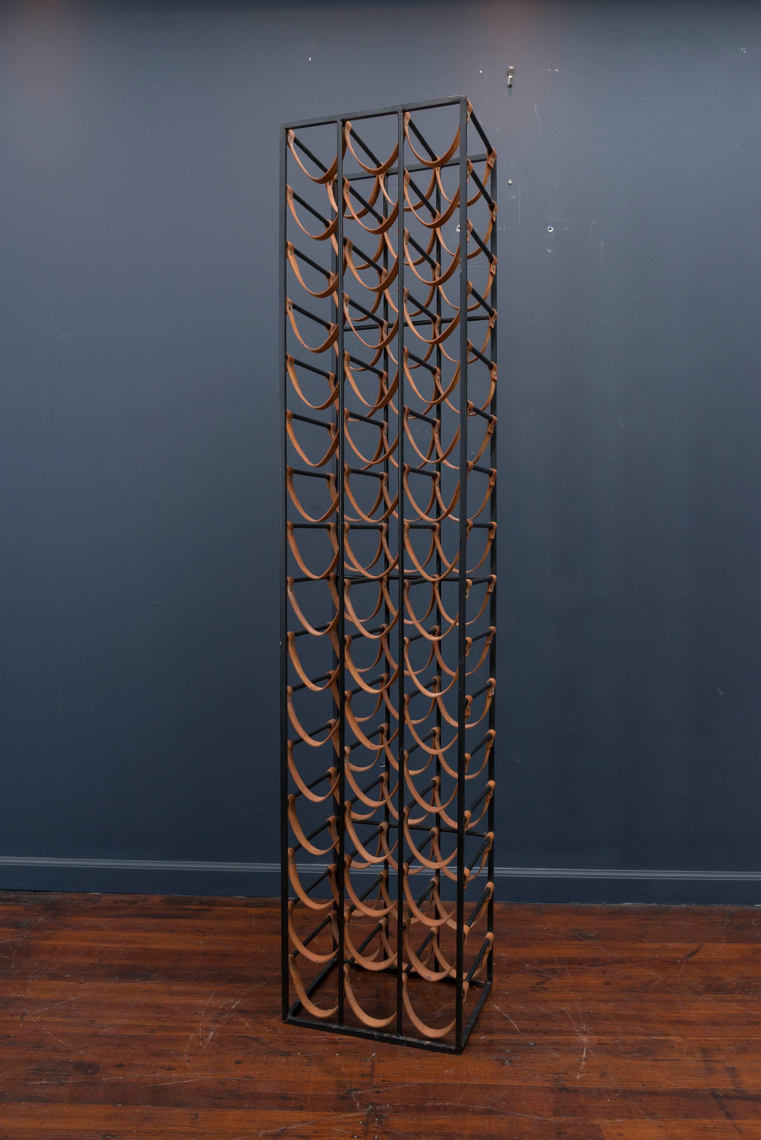 Arthur Umanoff flat black steel and natural leather strapped wine rack. Very good original condition, holds 48 bottles.