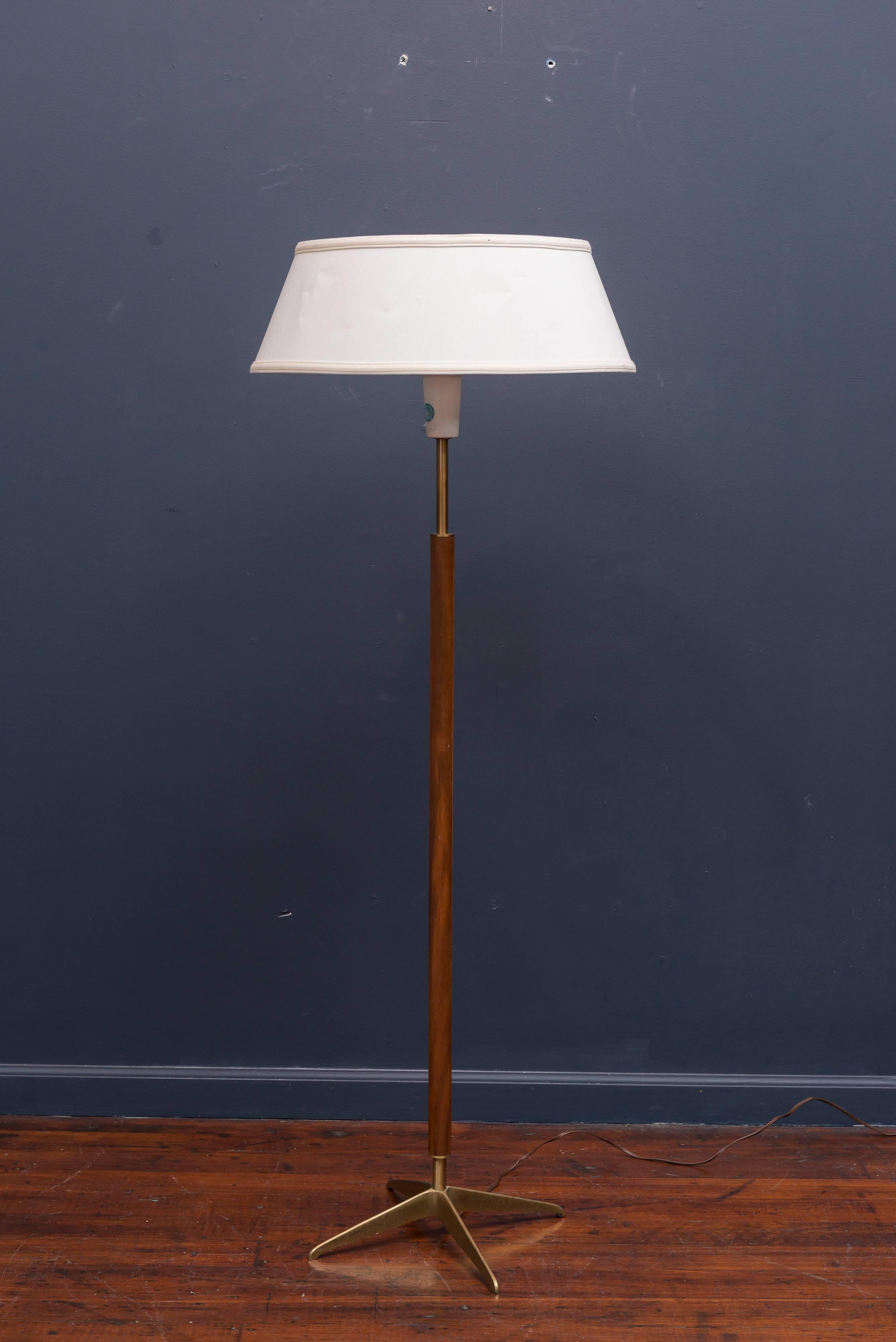 Classic Mid-Century Modern walnut and brass floor lamp designed by Gerald Thurston for Lightolier.