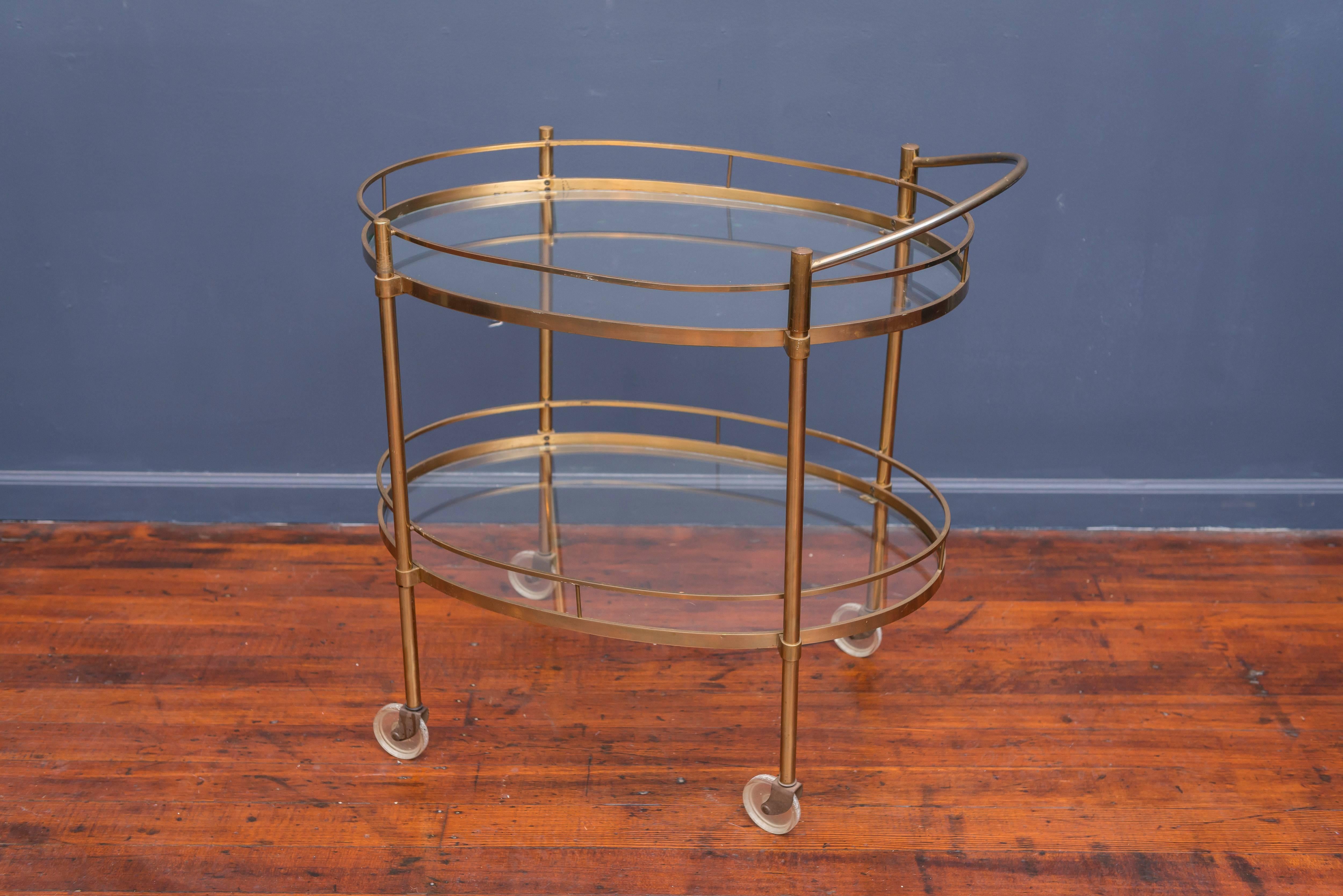 Hollywood Regency patinated brass and glass bar cart.