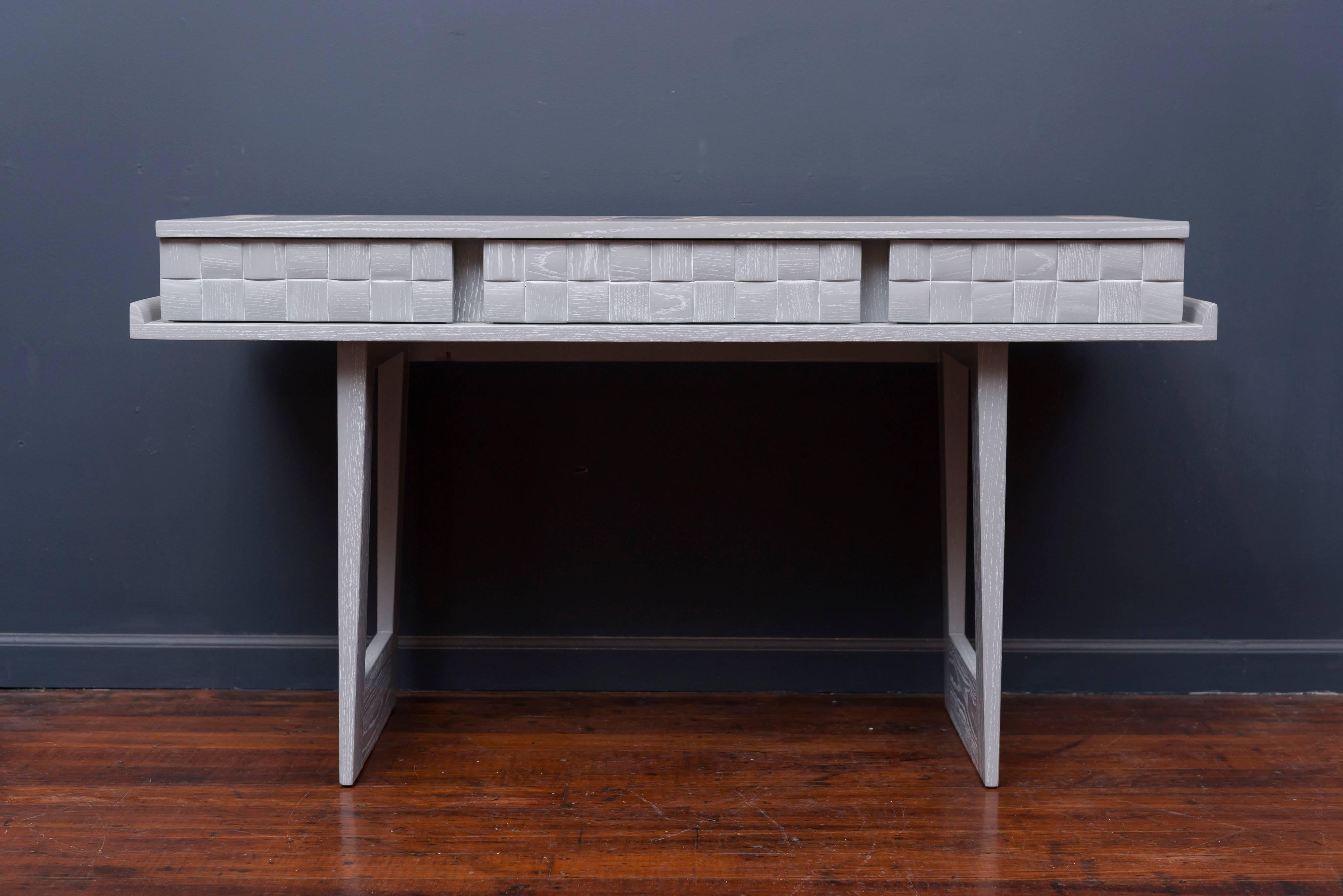Paul Laszlo design writing desk or console table for Brown Saltman Furniture Los Angeles, CA. Pickled oak finish in a light grey lacquer. Excellent restored condition.