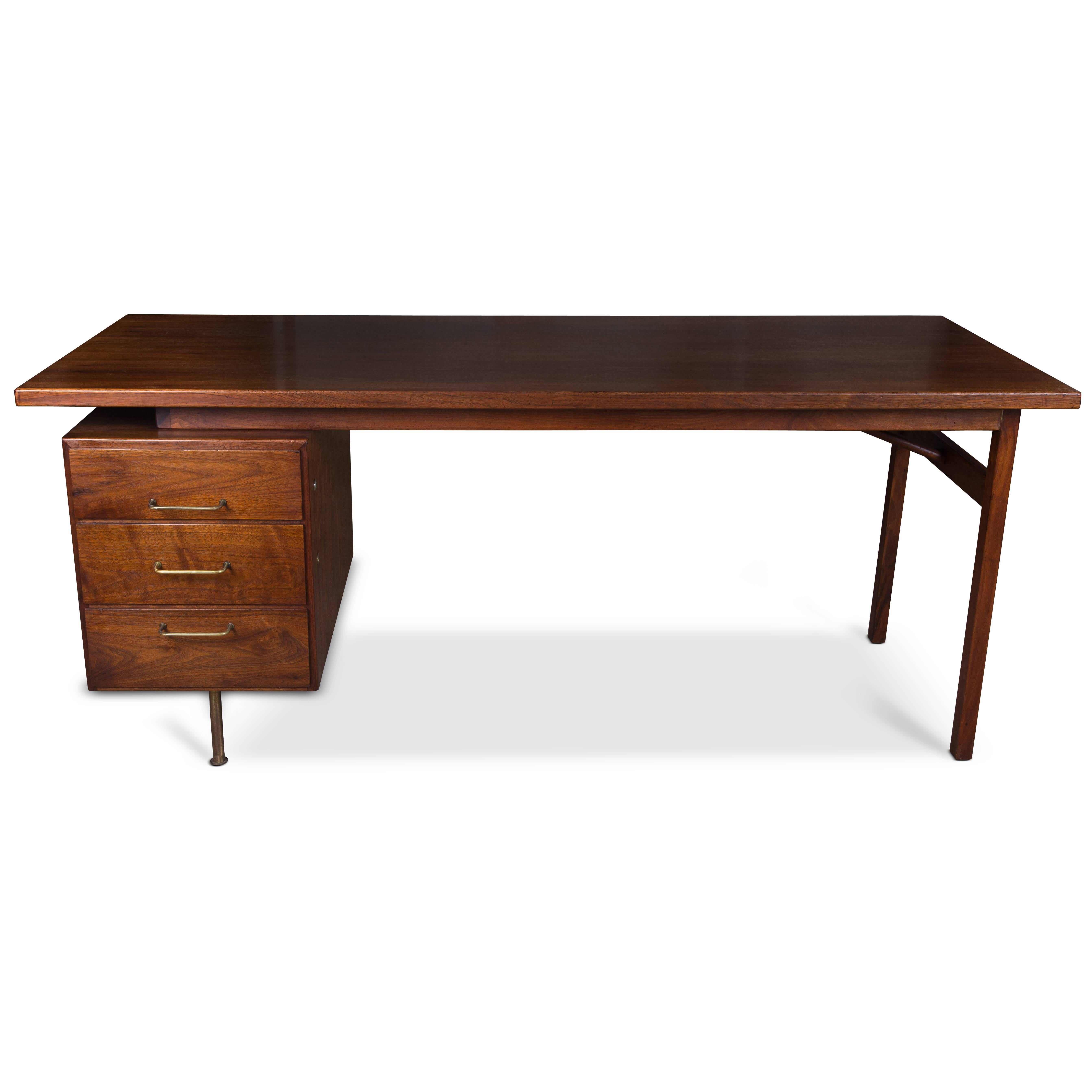 Rosewood desk with floating top and brass handles.