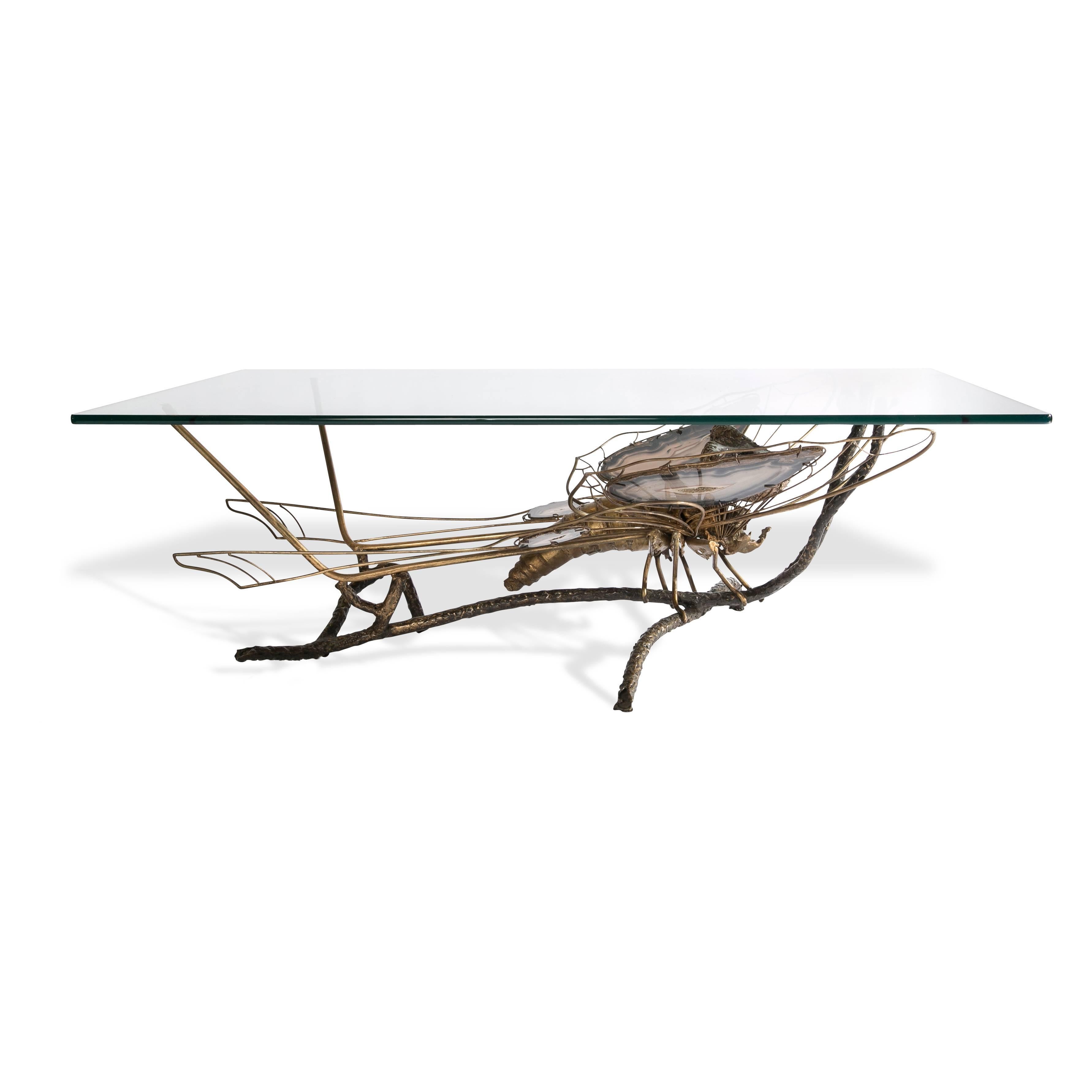 Sculptural butterfly cocktail table with geode eyes and grey agate crystal wings, brass form body.