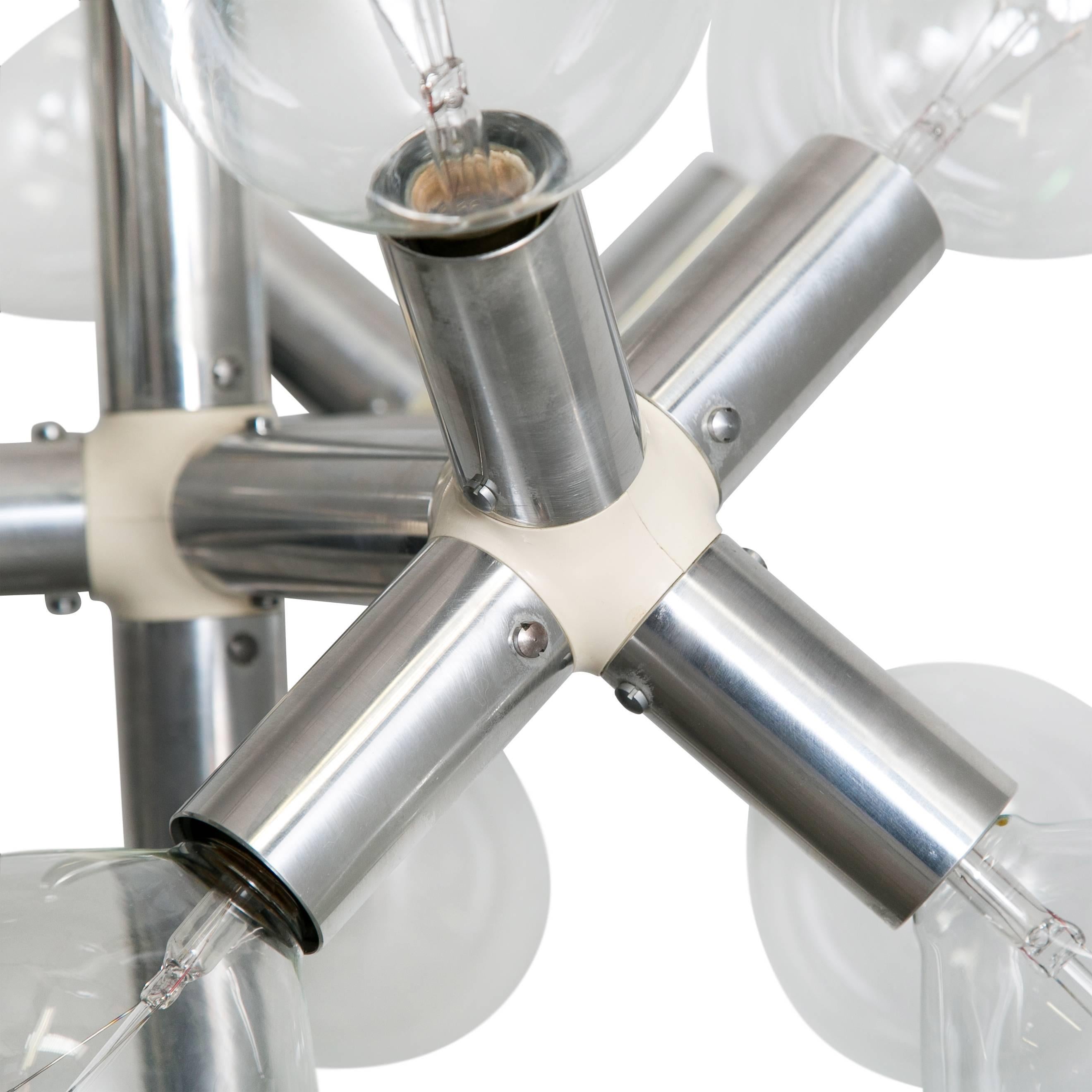 Chrome floor lamp with exposed bulbs produced by Swiss Lamps International.