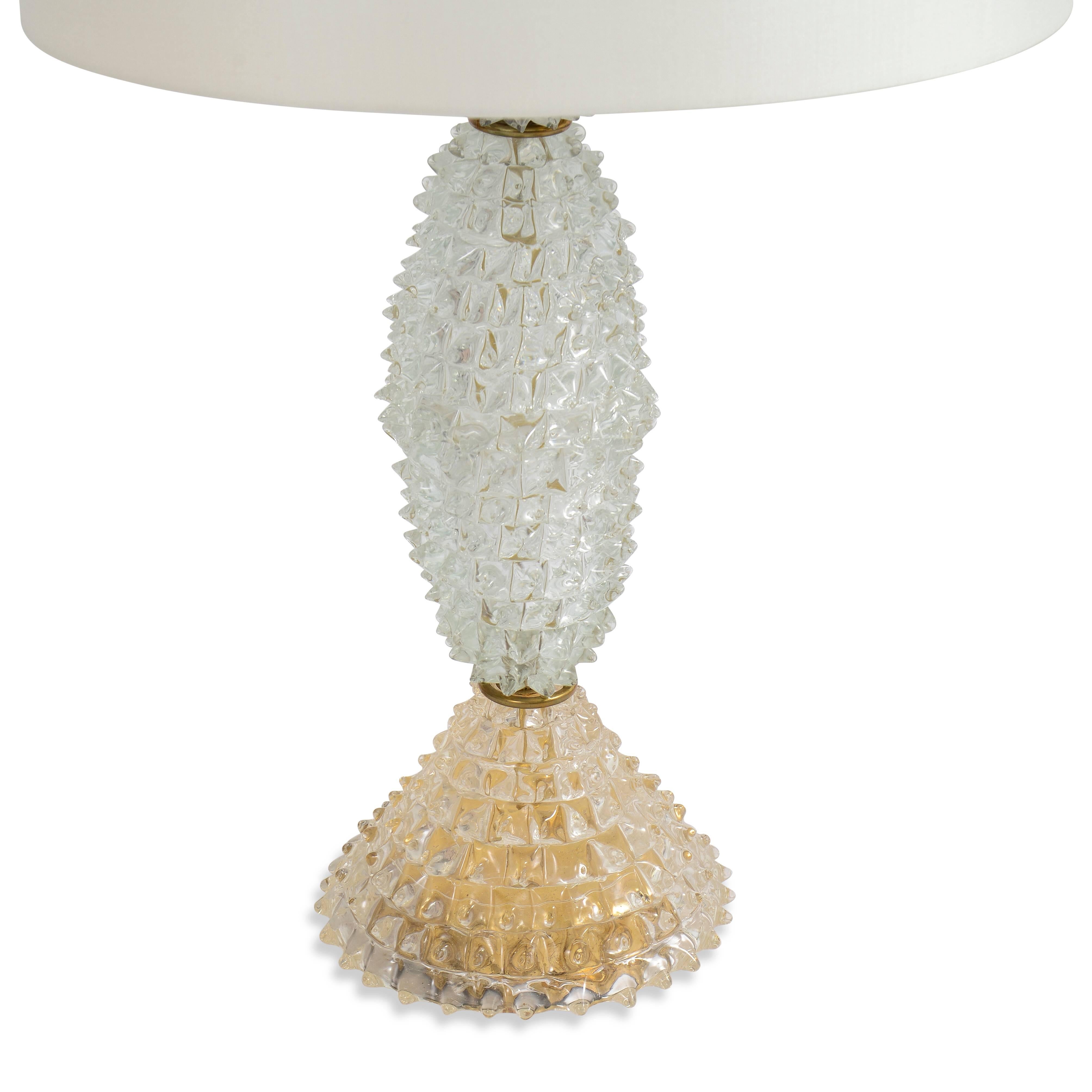 Molded glass table lamp on gilded stepped base.