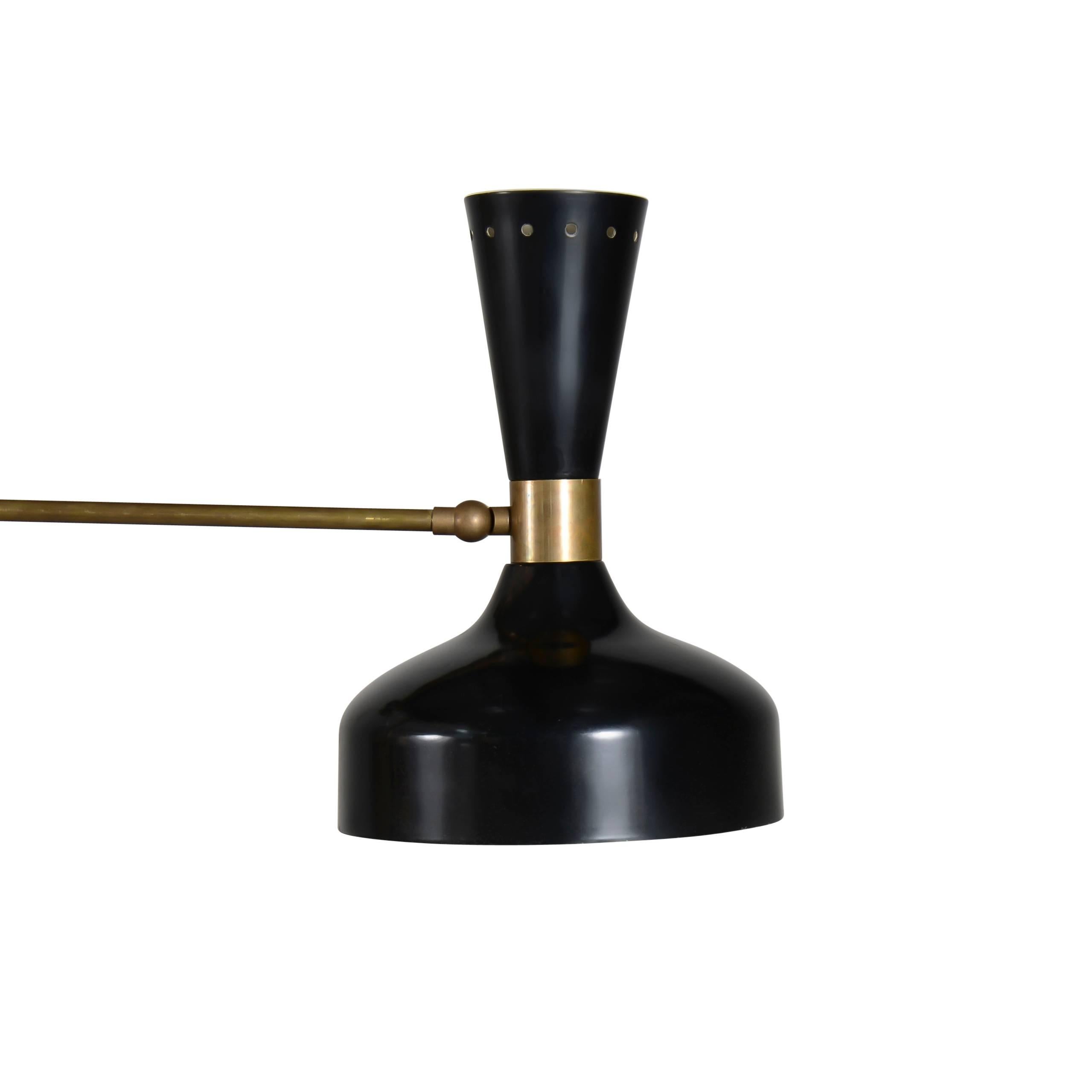 Brass three-light articulating chandelier with gloss black shades and counterbalancing spheres.