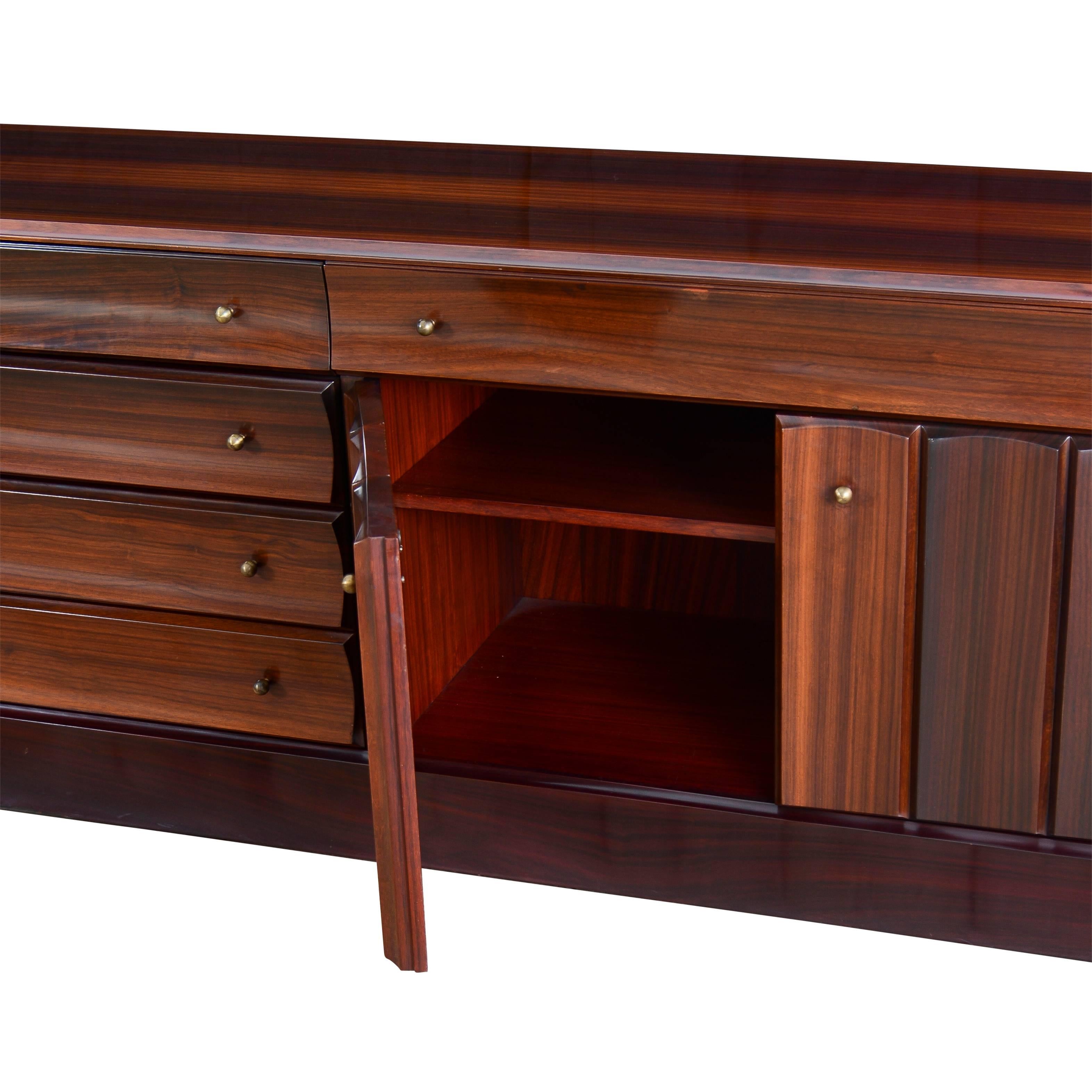 Solid rosewood and rosewood veneer sideboard with brass pulls.