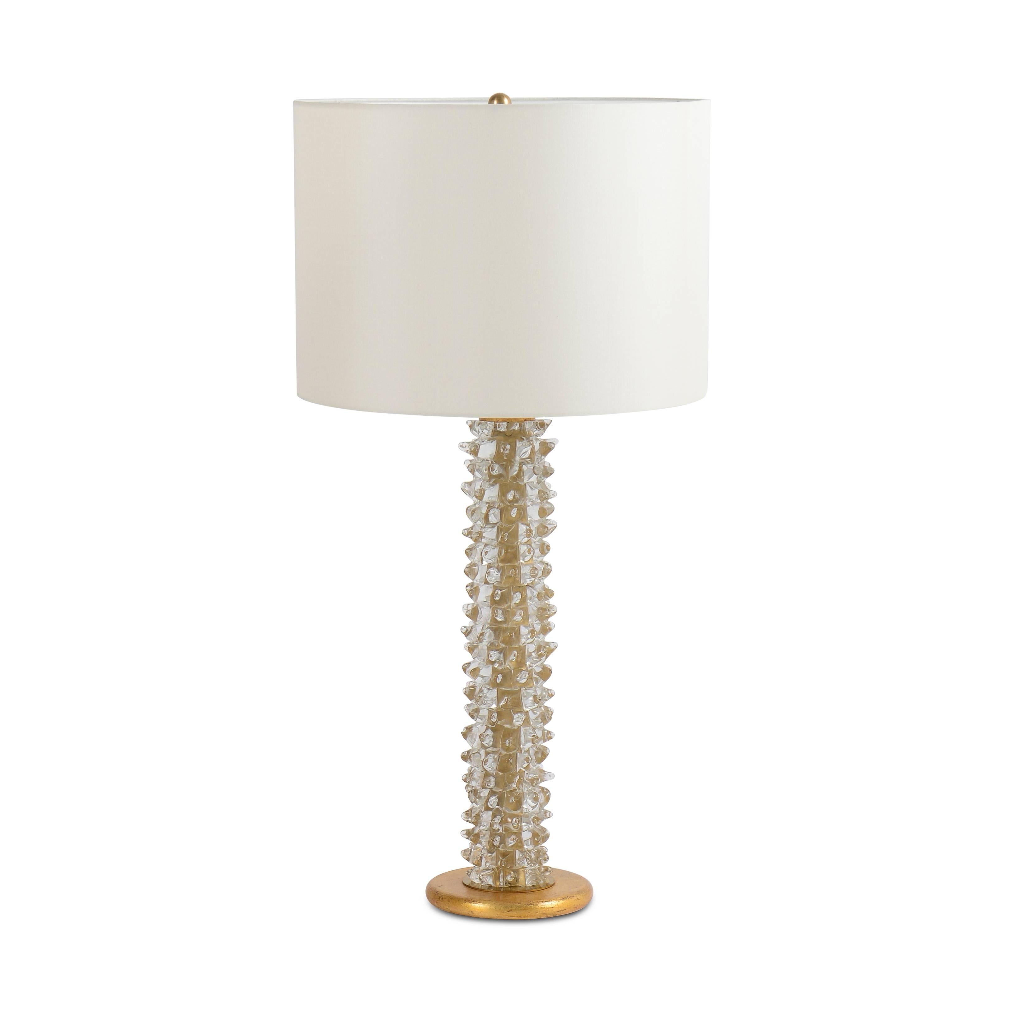 Pair of molded glass table lamps on round gilded stepped base.