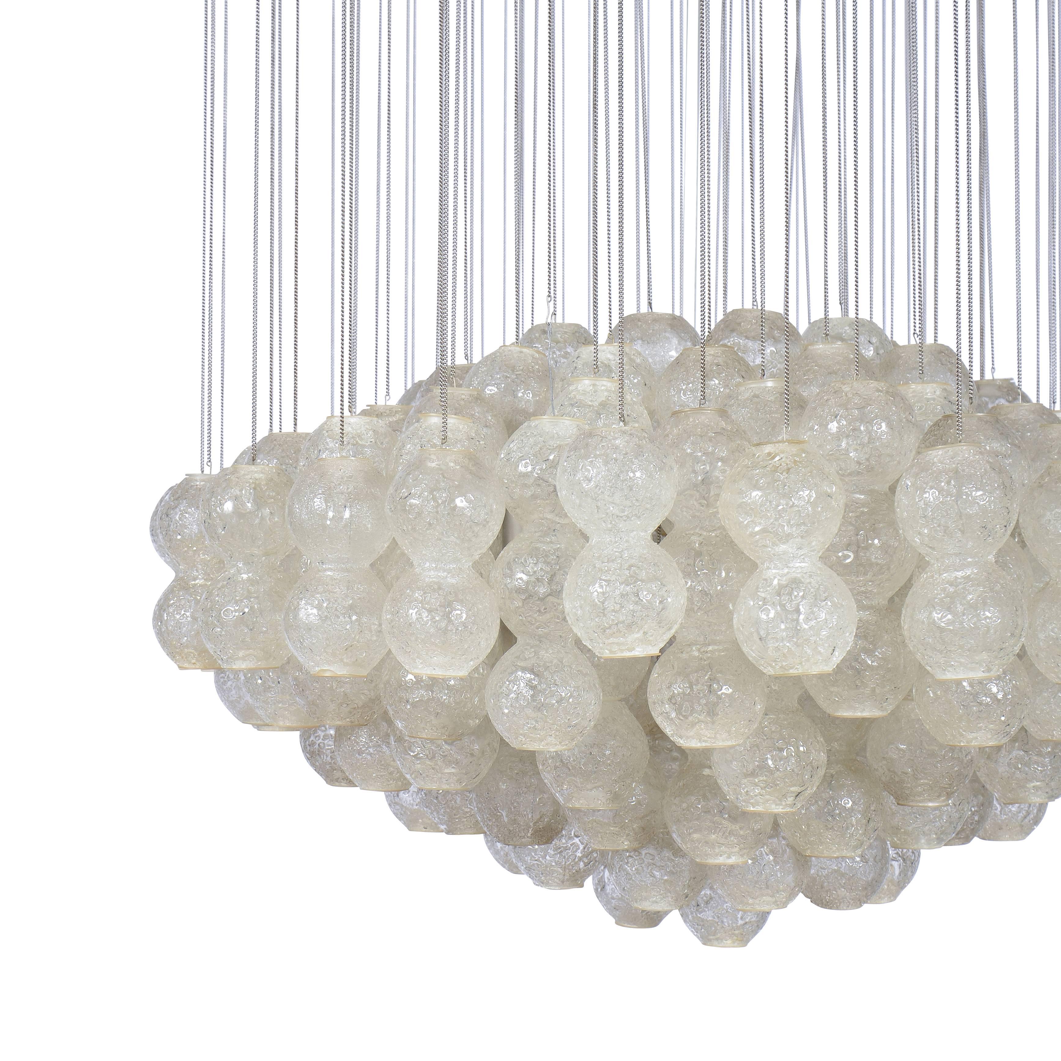 Sculpted star shade chandelier with chained hanging glass clusters.
