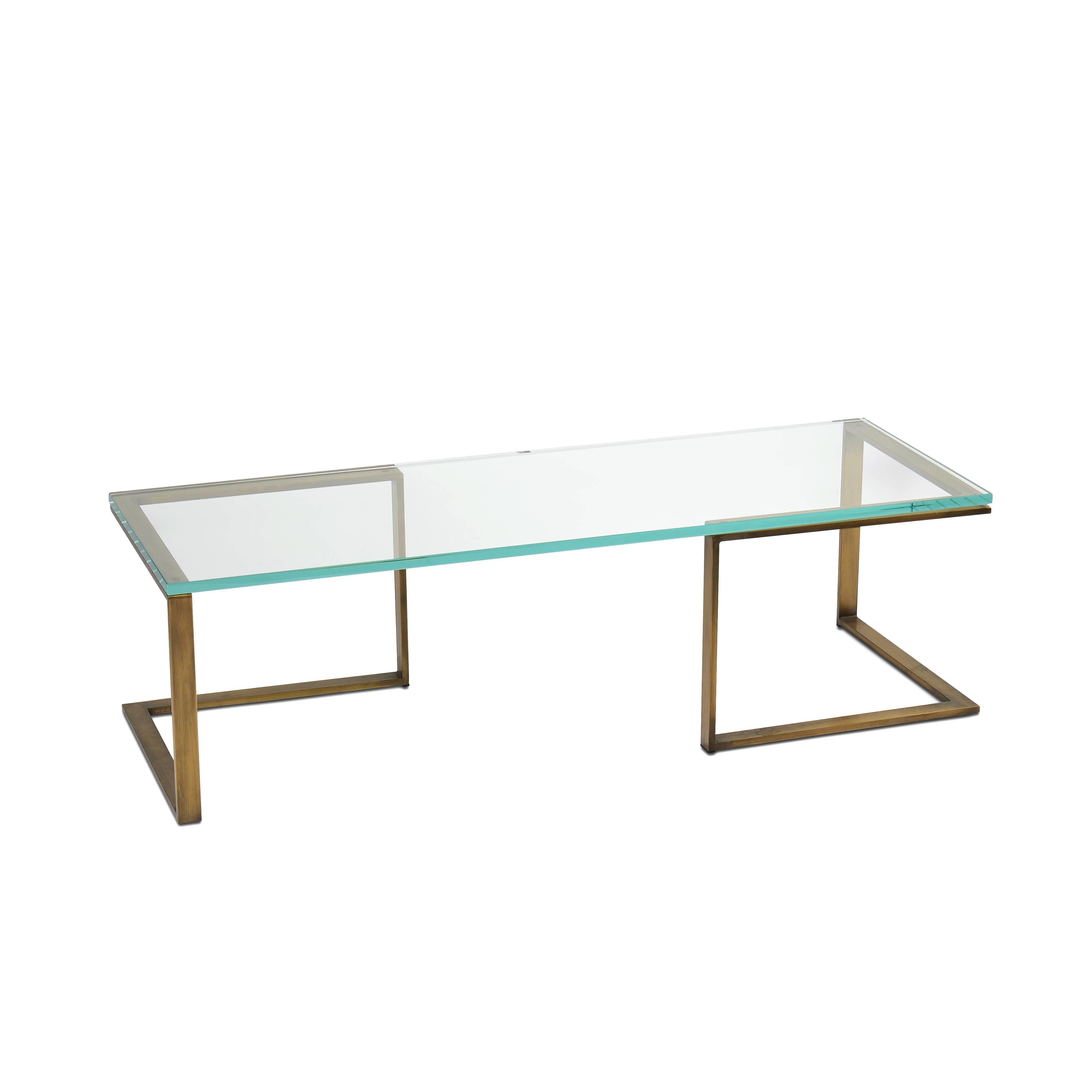 Two-piece cocktail table in bronze and steel with glass top.
  