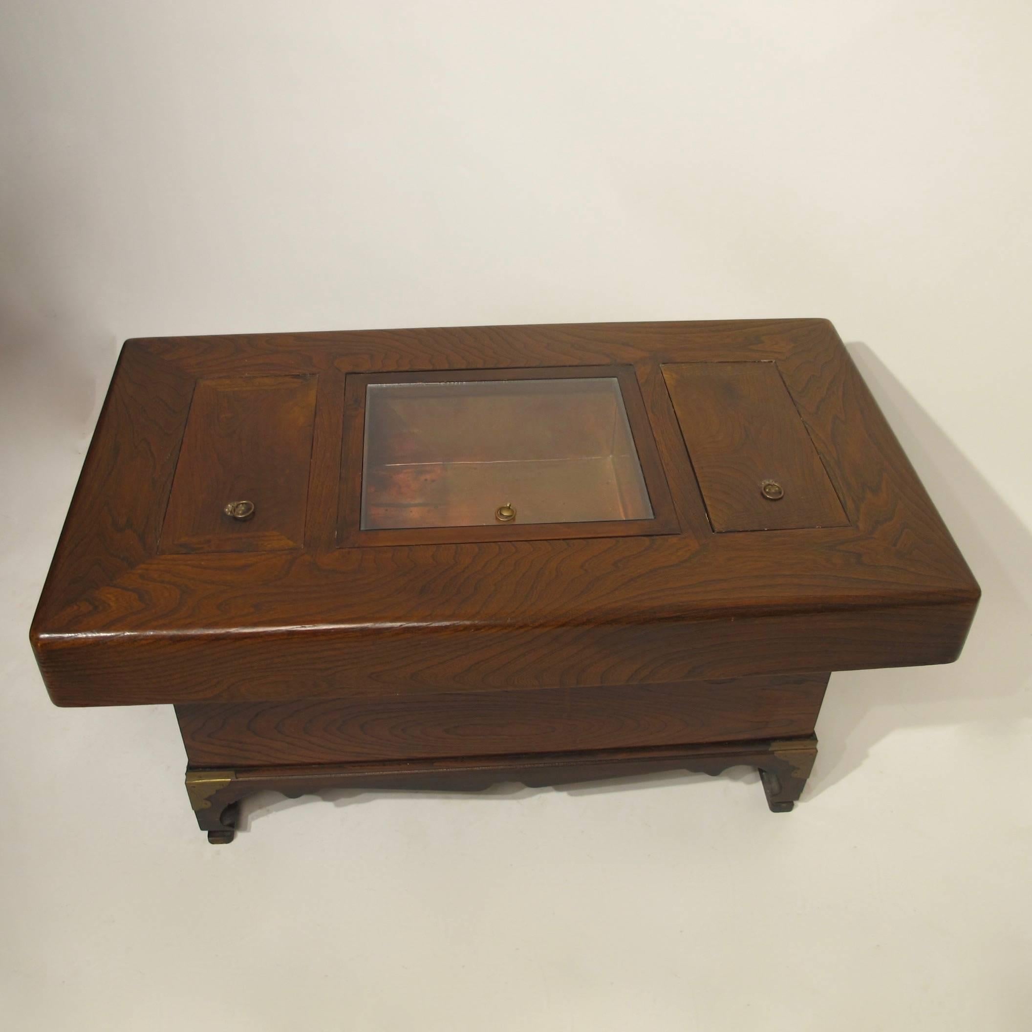 Kiri wood hibachi on custom stand with three copper lined compartments, two with wooden lids and the larger middle section having a fitted glass cover.