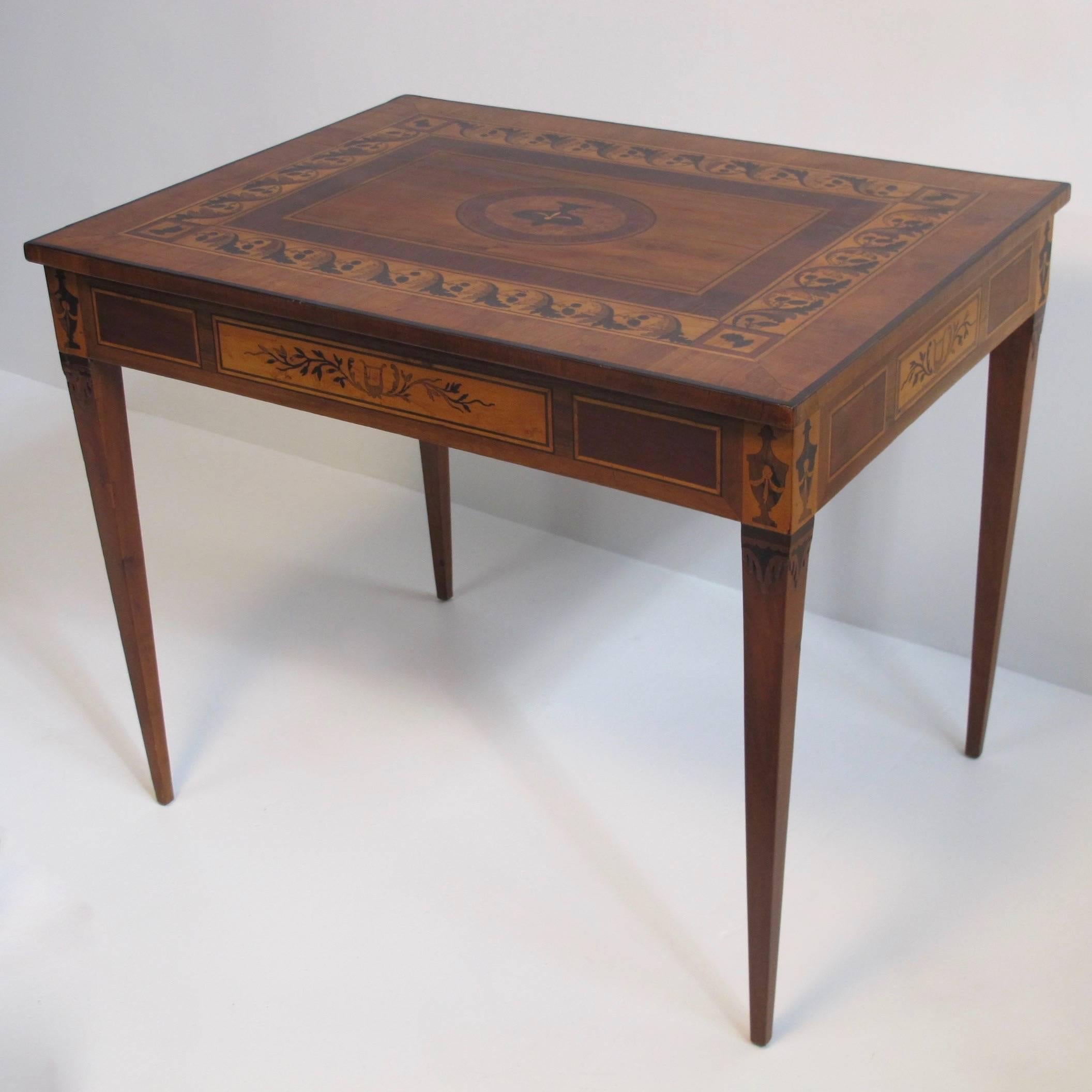 An exceptional parquetry inlaid writing table with Neoclassical designs, inlay with satinwood, black walnut, and fruitwood. Having a single center drawer, and supported on tapering legs.
Italian, circa 1790.
