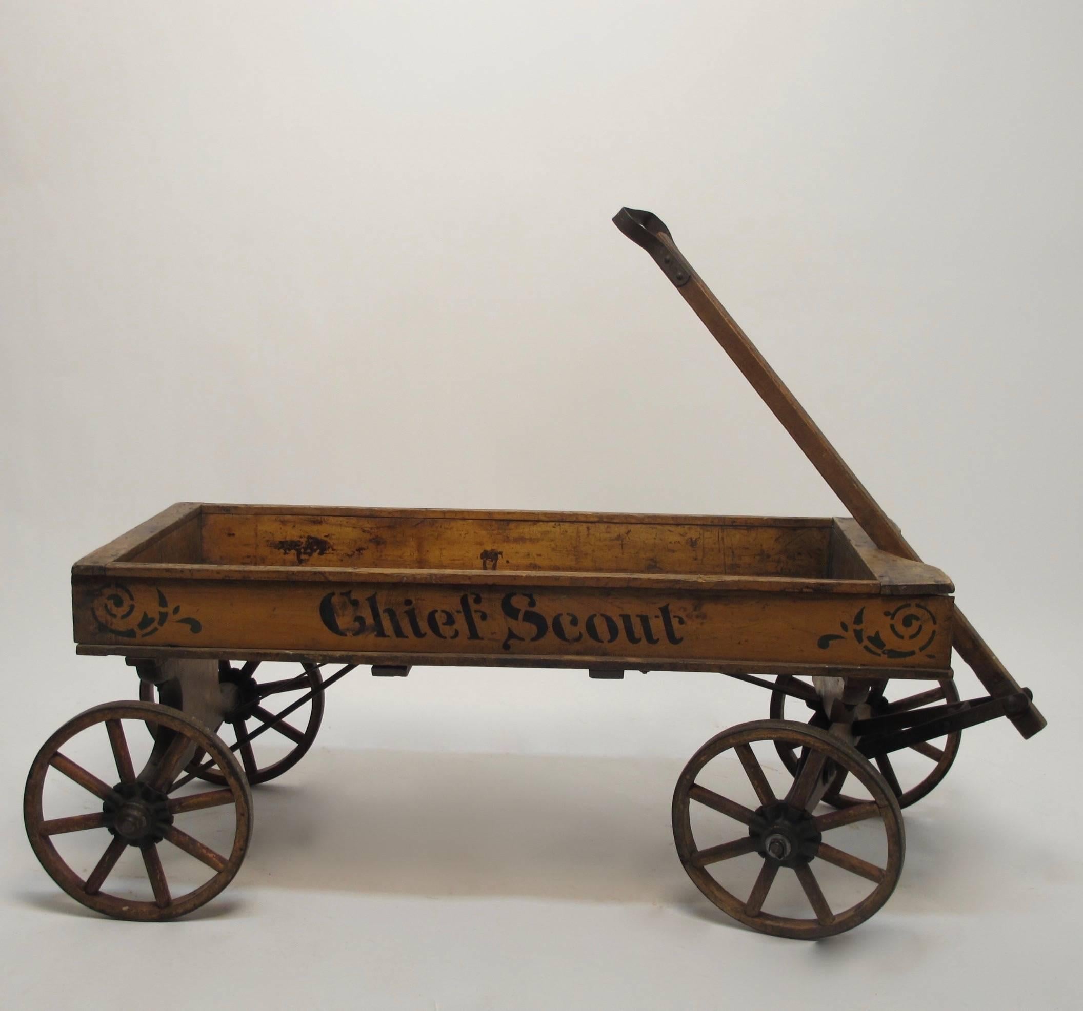 Original antique Chief Scout child's wagon in remarkably good condition with original finish, paint and stenciling. American made by Lewis-Geer MFG. Co. The last owner used as a coffee table with a glass top.