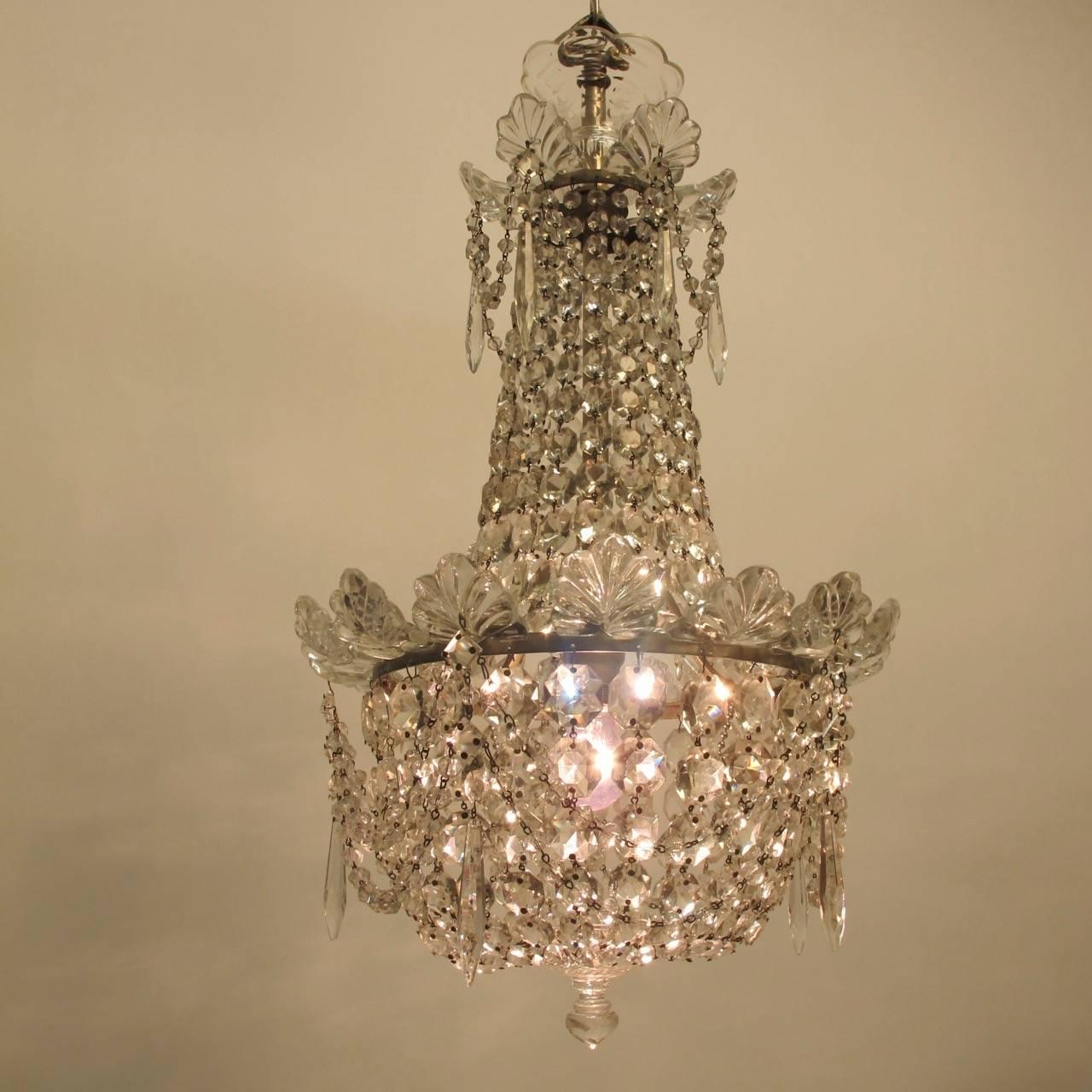 A good quality 1920s petite size crystal and glass chandelier. Newly re-wired. Height including chain and canopy is 45 inches.