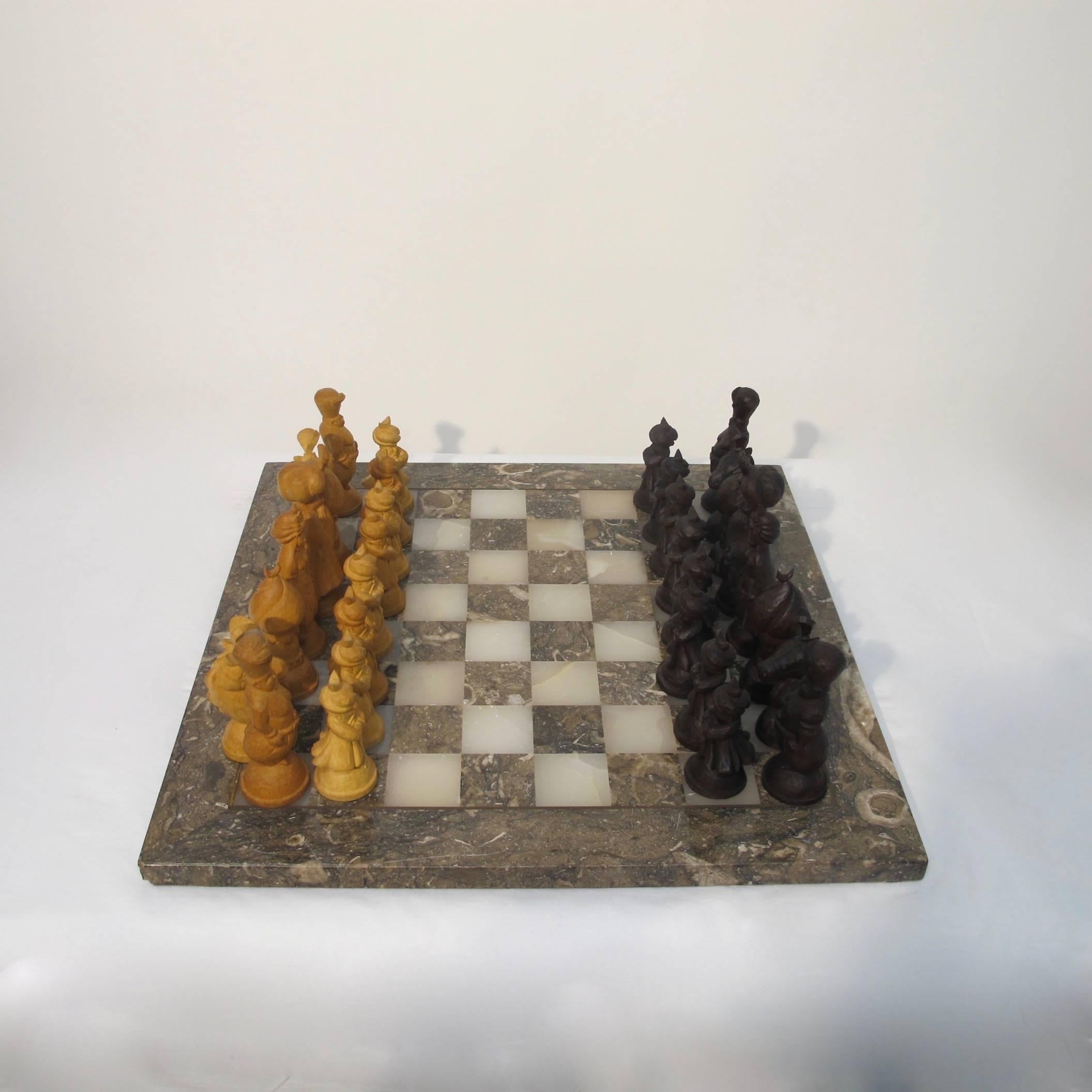 A beautifully fossilized marble and onyx chess board with inlaid brass detail, all hand-carved ottoman figures (the tallest measuring 5 inches high). Inlay box with fitted interior to house chess pieces. Game board measures 18