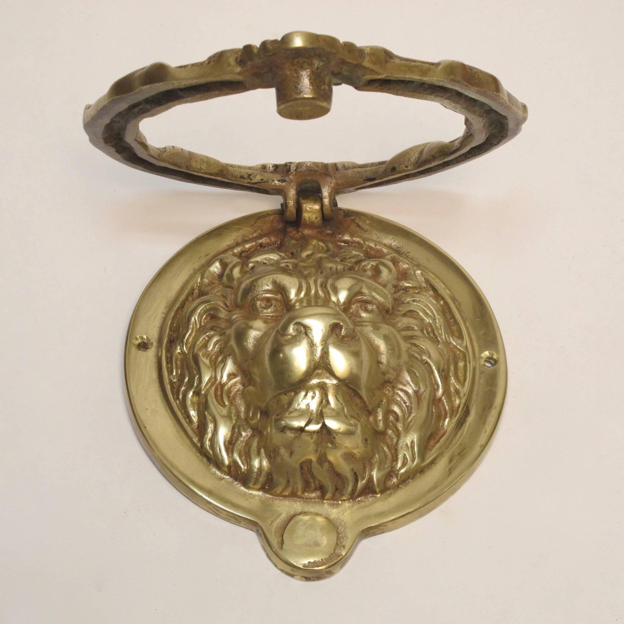 A large scale wonderfully cast brass lion doorknocker. Recently polished, early to mid-20th century.