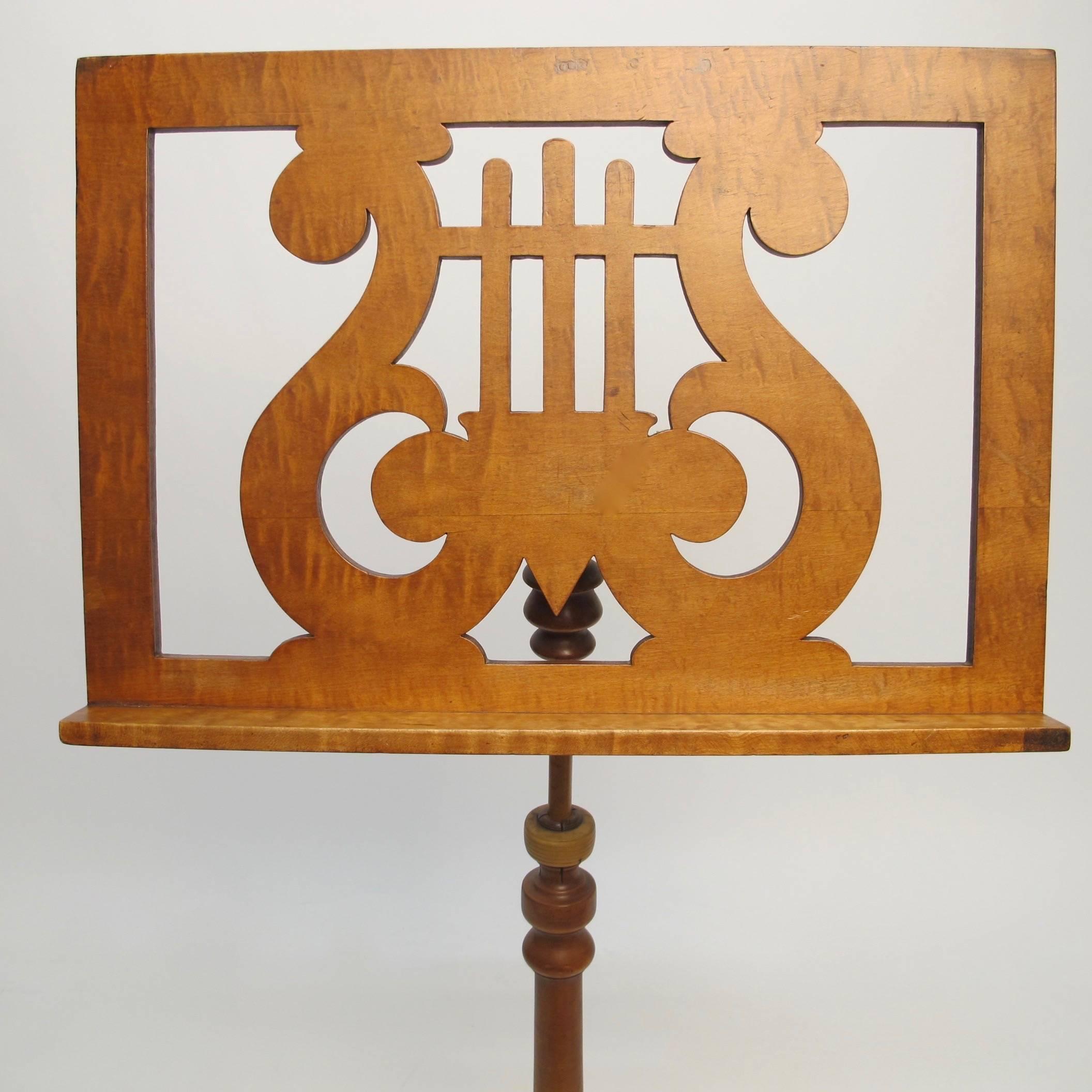 Handsome adjustable music stand made of maple, tiger maple, and black walnut. Maximum height is 48 inches. American, late 19th century.