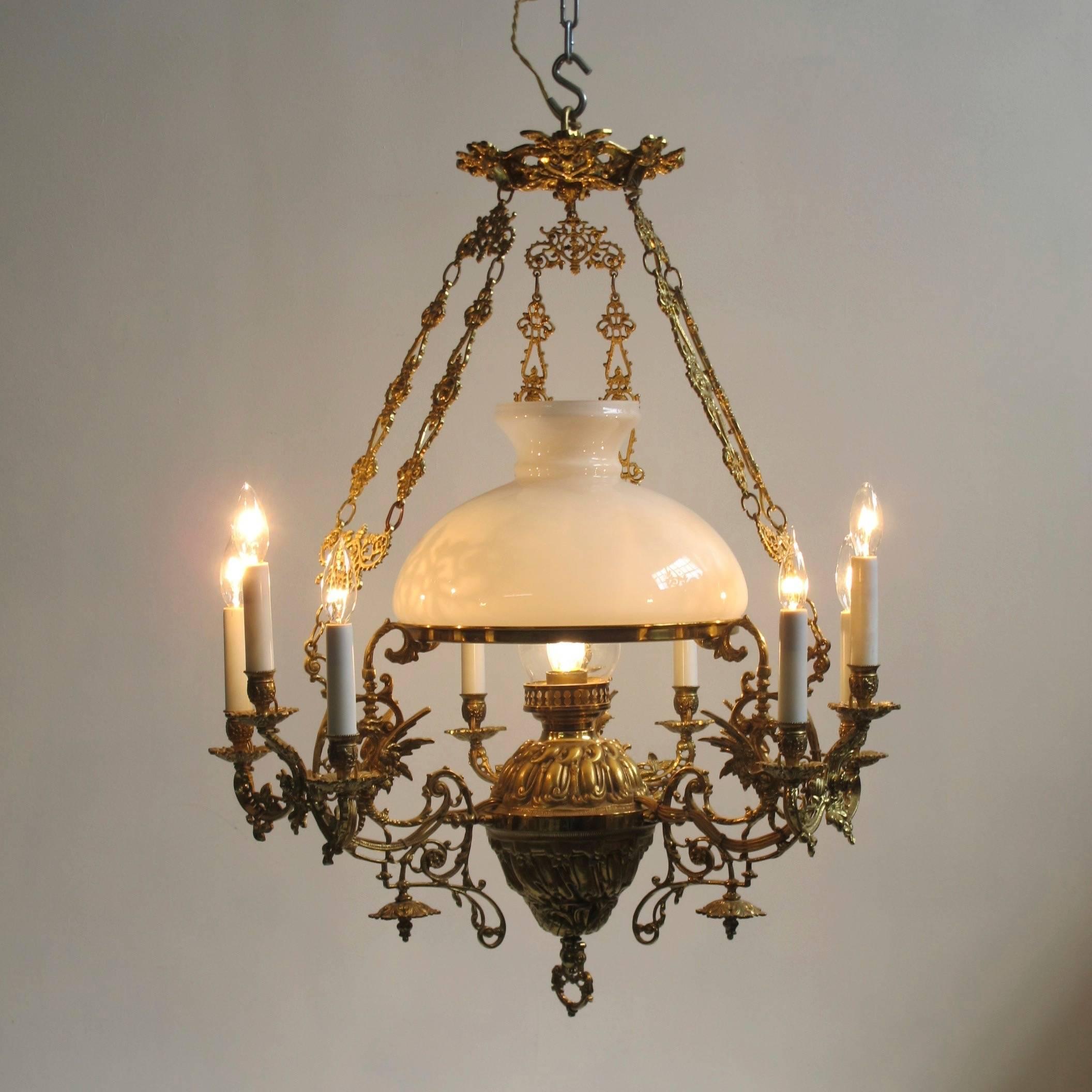 Solid brass kerosene and candle light fixture now electrified and restored. Original glass shade and with ten arms electrified with chandelier size bulbs. Excellent quality. Dutch, circa 1880-1900.