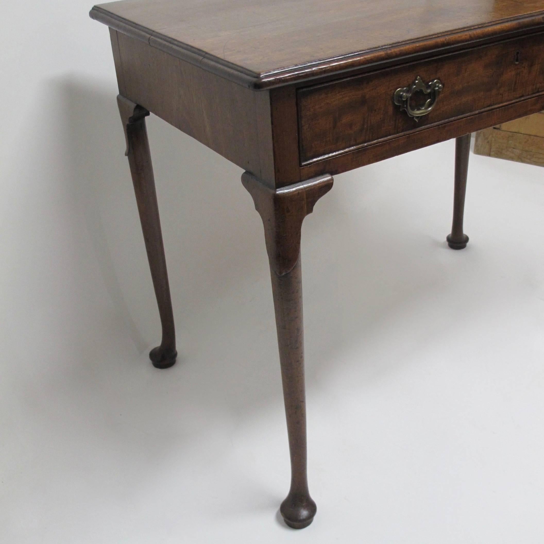 Irish mahogany single drawer writing table with brass pulls, carved knees, ending in Queen Ann pad feet. Irish, circa 1790.