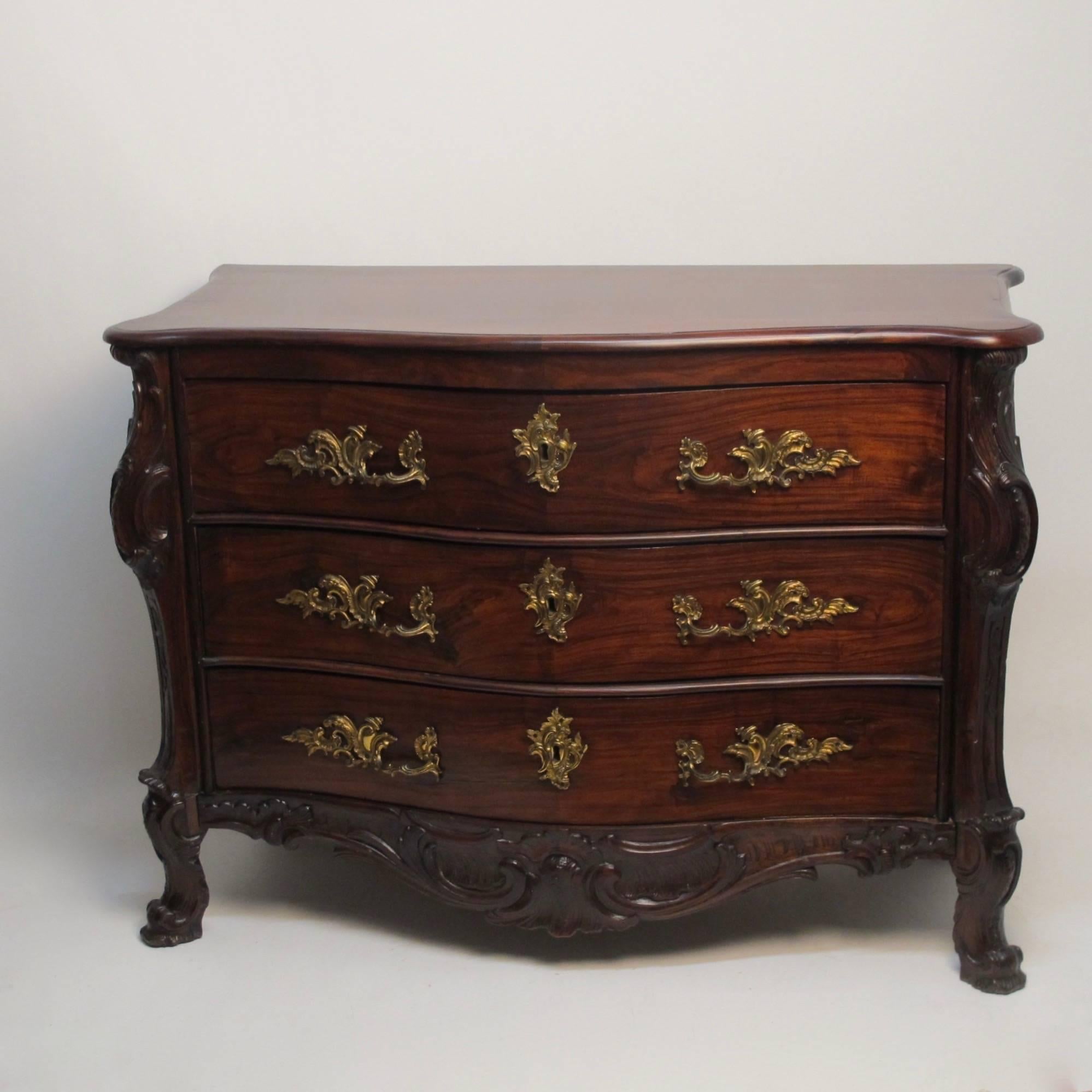 Beautifully carved solid rosewood three-drawer chest of drawers. Having original hardware and in remarkable original condition with some expected old minor repairs. Portugal, late 18th century/early 19th century.