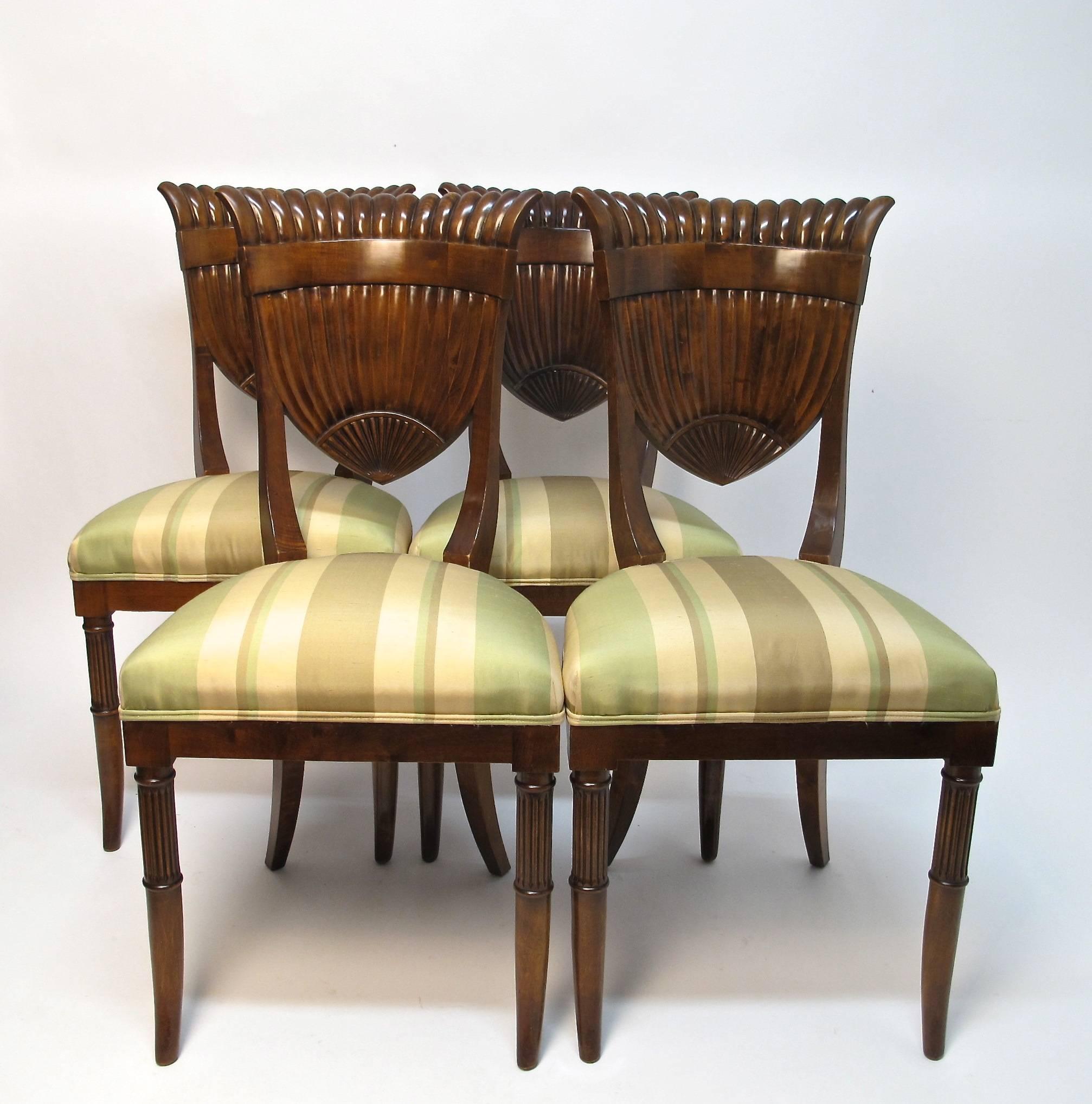 Exceptionally stylish set of four Italian (made in the Biedermeier style) dining chairs/side chairs with a fan or shield shaped back and newly upholstered seats. Italy, mid 20th century.