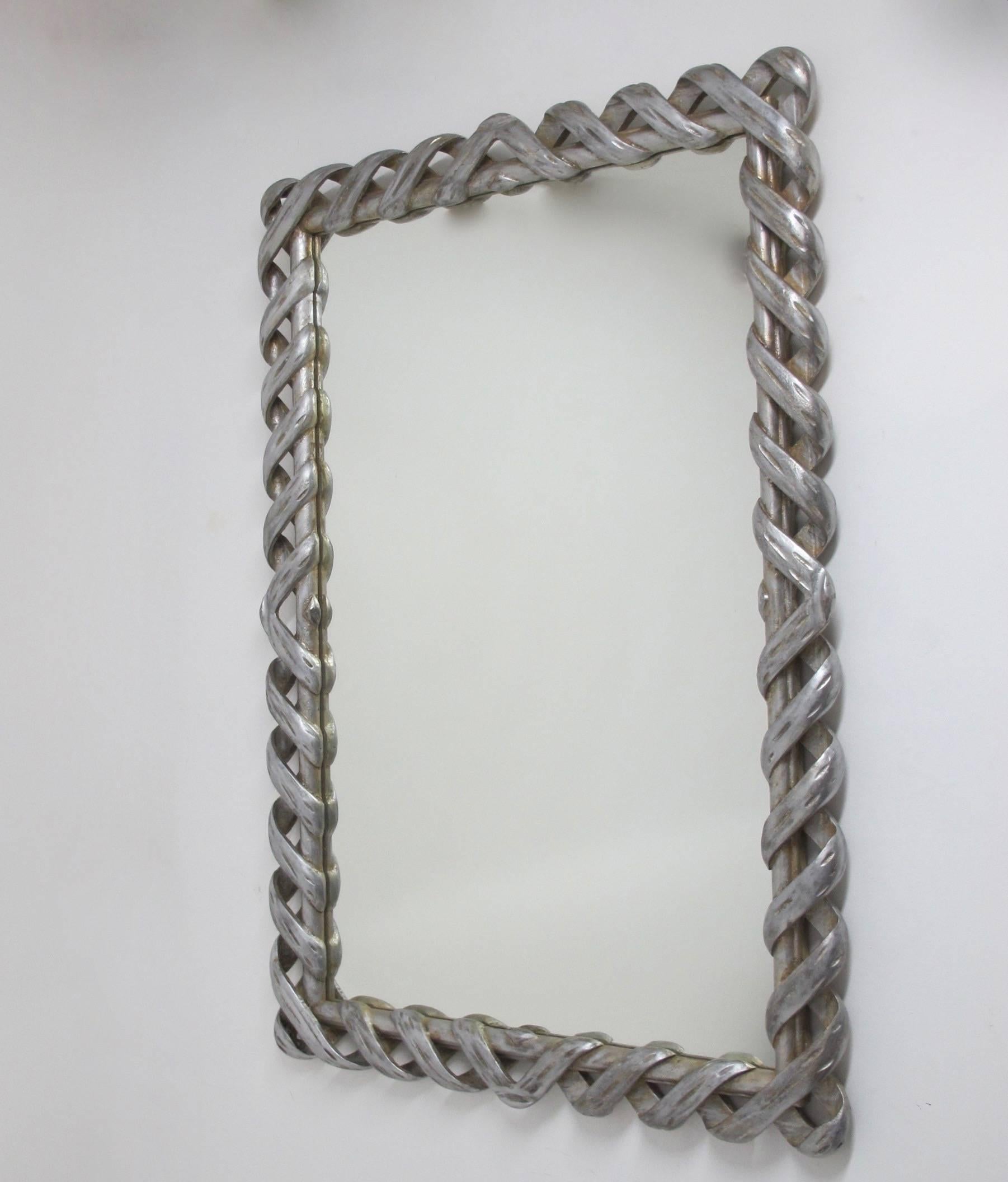 A large and highly unusual carved and silvered wood mirror, Italian, 1950s-1960s. Can hang vertical or horizontal. Newer replaced mirror.