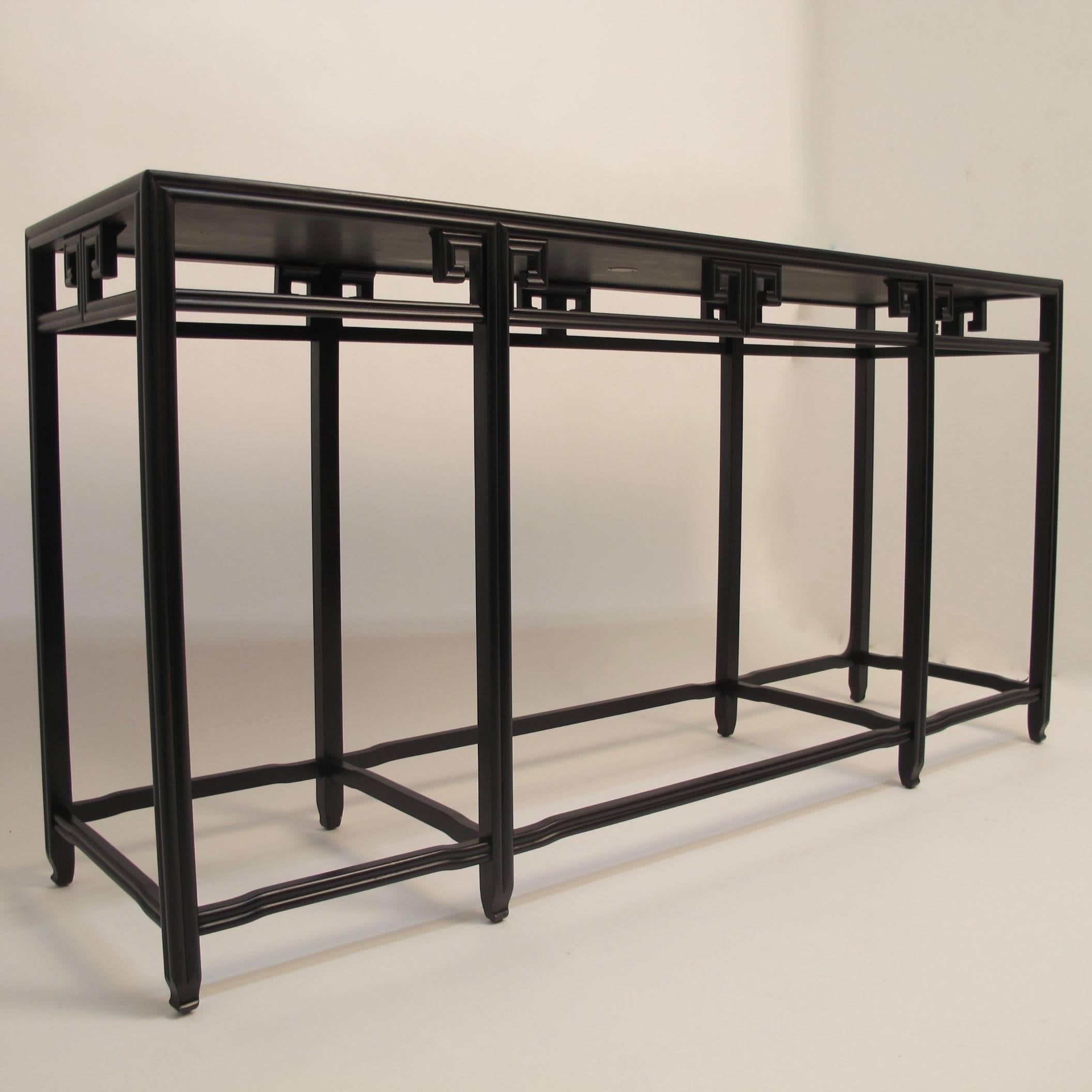 Black lacquer Asian style console or sofa table by Baker Knapp & Tubbs with molded details, circa 1970, American.