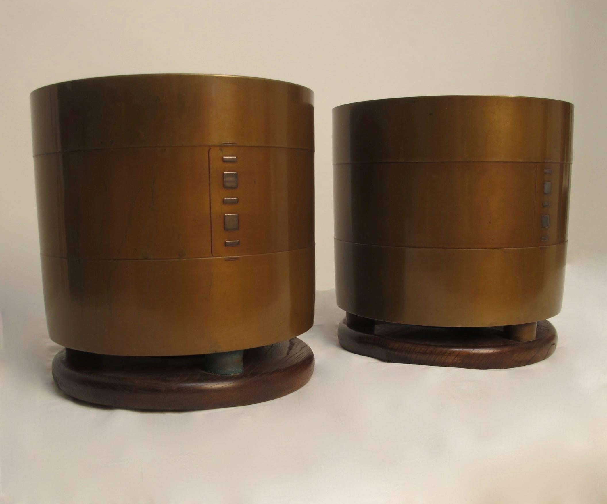 A superb pair of bronze planters with original box and cloth liners. Having silver inlay detail on the bronze, the urns are affixed to Kiri Wood bases. Reputedly from the collection of John Traina. Black lacquer stand included. Japan, early Showa