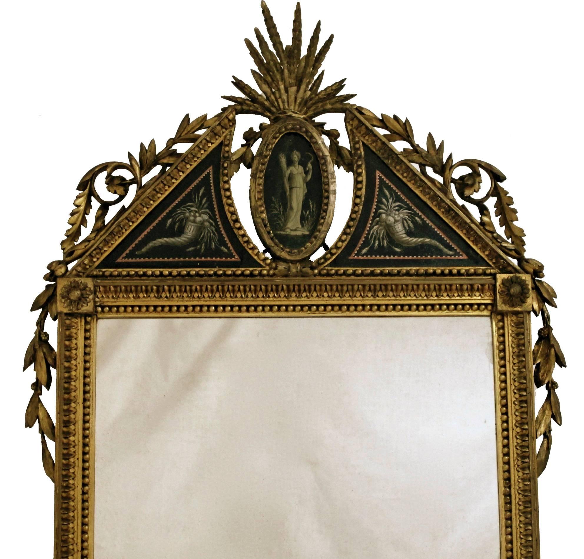 Exquisite French mirror. Finely carved and giltwood frame with hand-painted églomisé (reverse painted on glass) panels and original mirror, France, mid-late 18th century.
