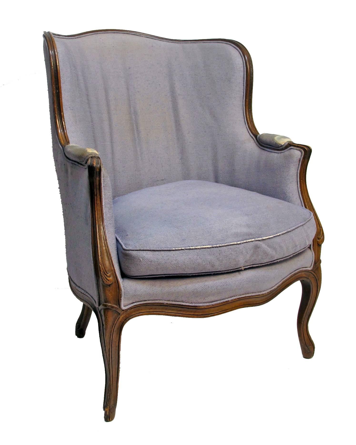 A good quality traditional style carved bergere chair with solid sturdy beechwood frame. Having original label for Yale R. Burge. In need of new upholstery.