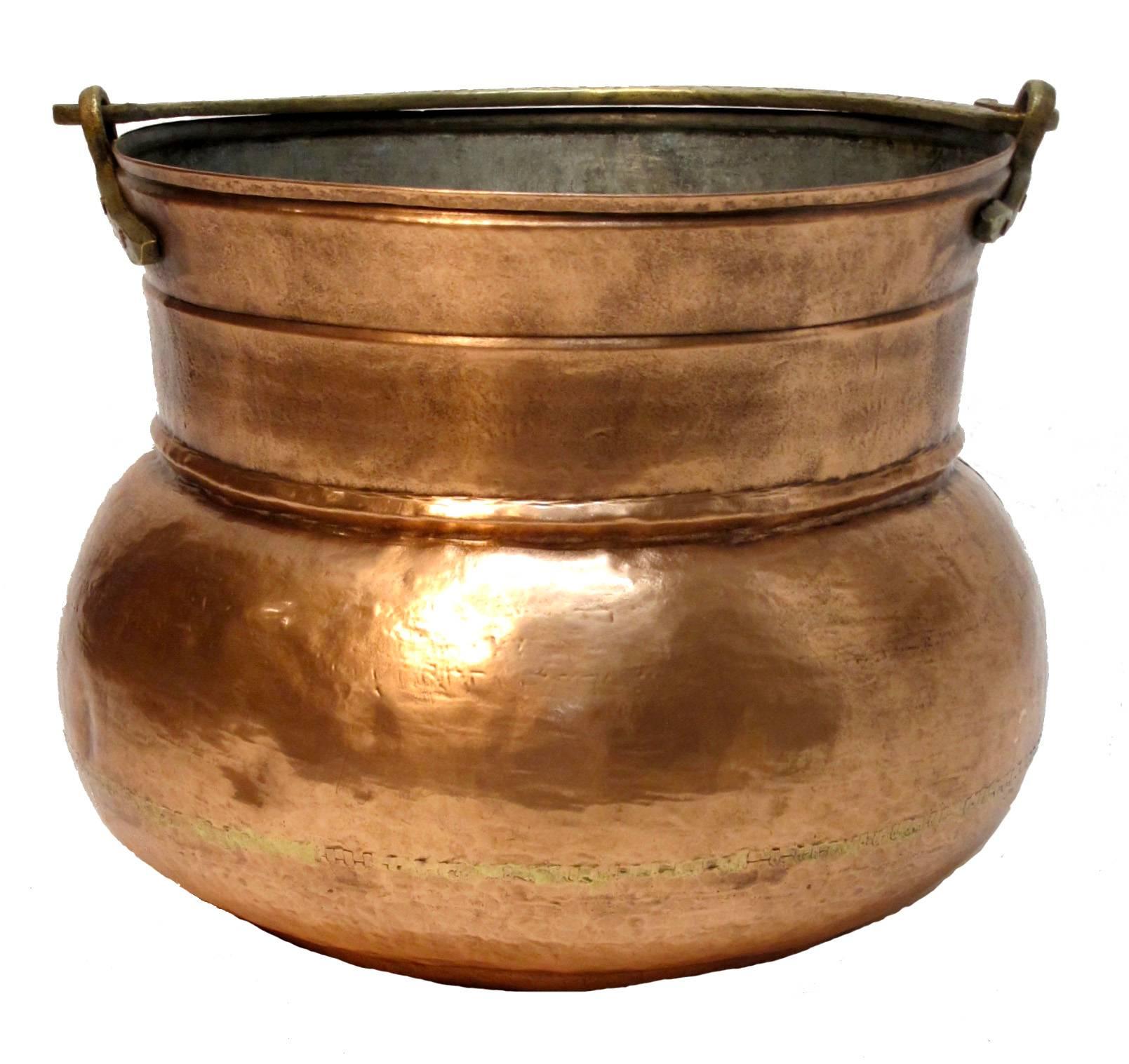 A large hand-hammered copper pot with brass handle. Continental European, 19th century.