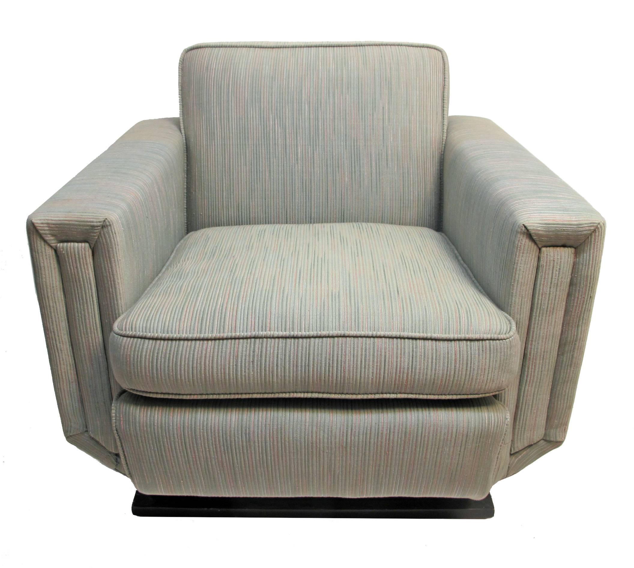 A mid-20th century oversized club chair or armchair, having good form and lines. This is the original upholstery and it is in fair condition.