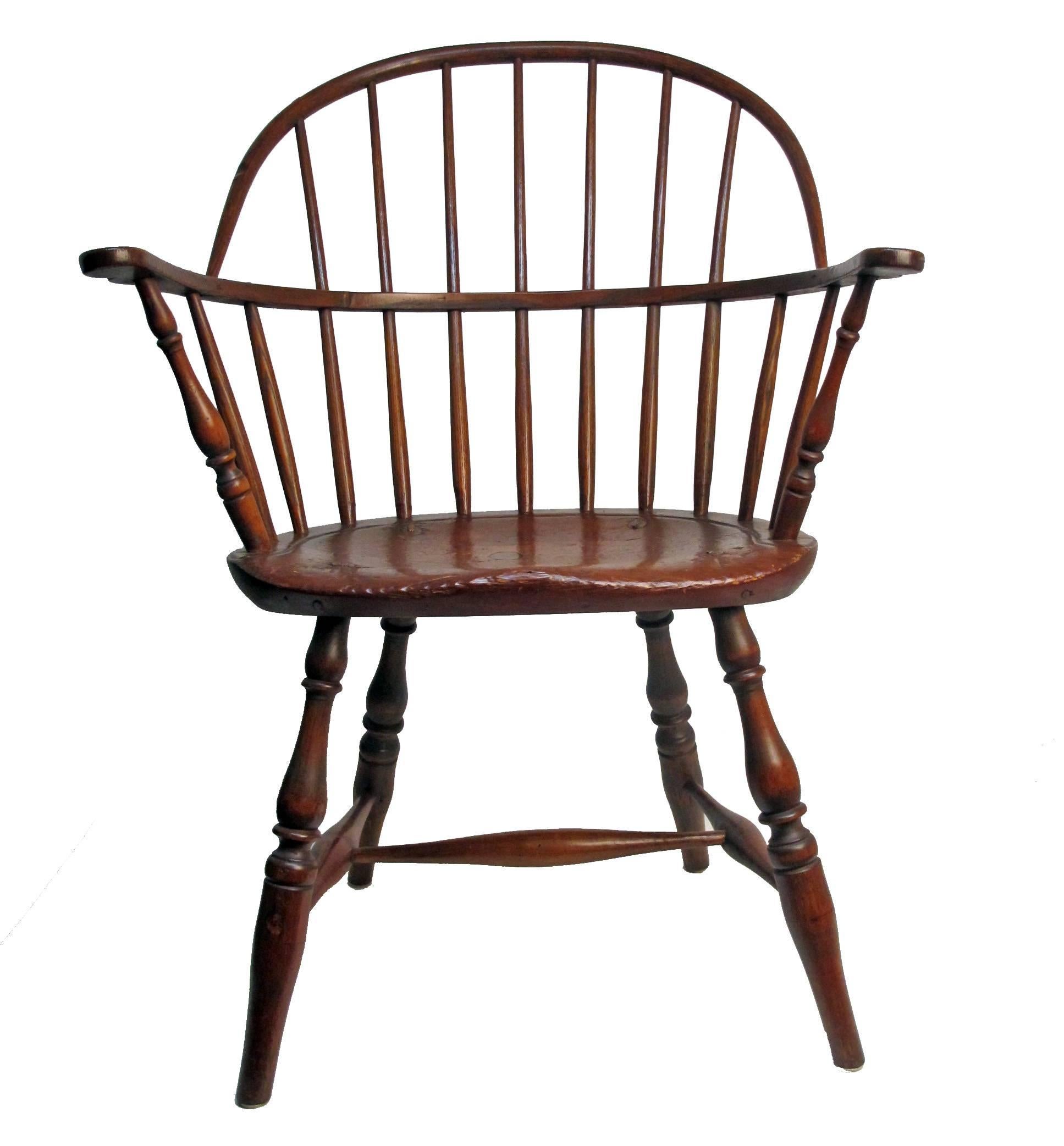 An early 19th century American windsor chair of mixed woods with remnants of original old paint.