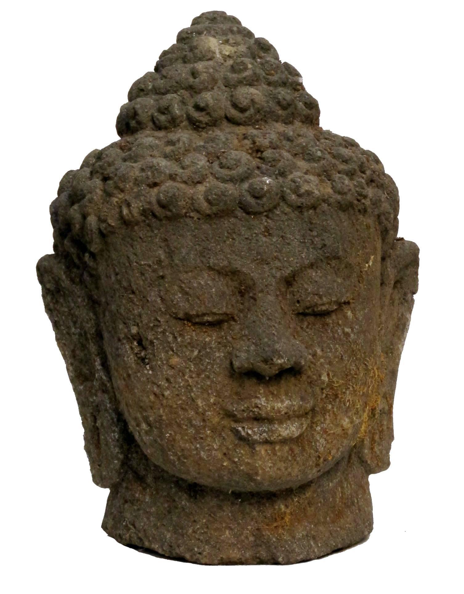 A large volcanic stone Buddha sculpture. This Buddha has sat in a garden for over 30 years and shows beautiful weathered age and moss growth. Chinese, mid 20th century.