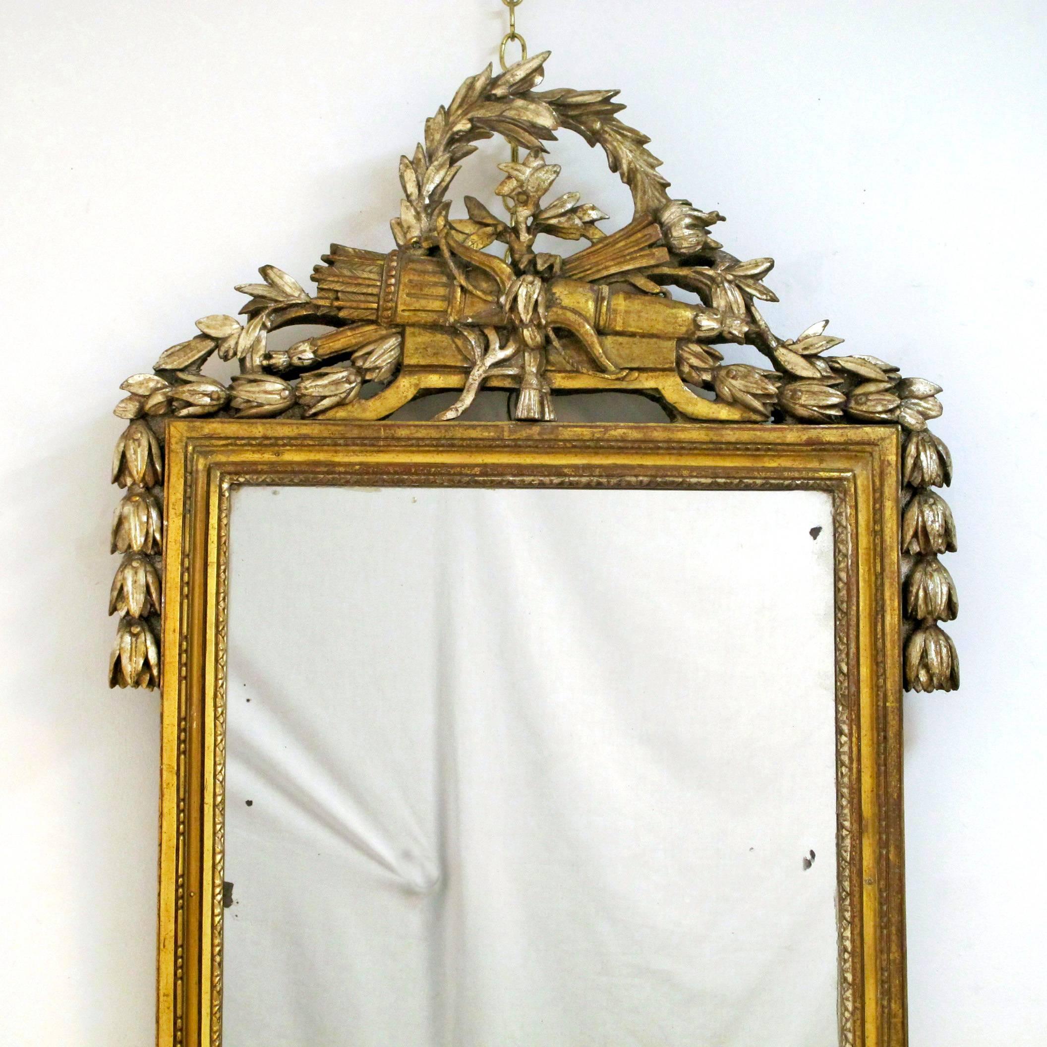 Highly unusual white gold gilt Louis XV carved mirror with swags,
of leaves, crossed arrows and quiver below a crown wreath of laurel leaves,
French, circa 1780.