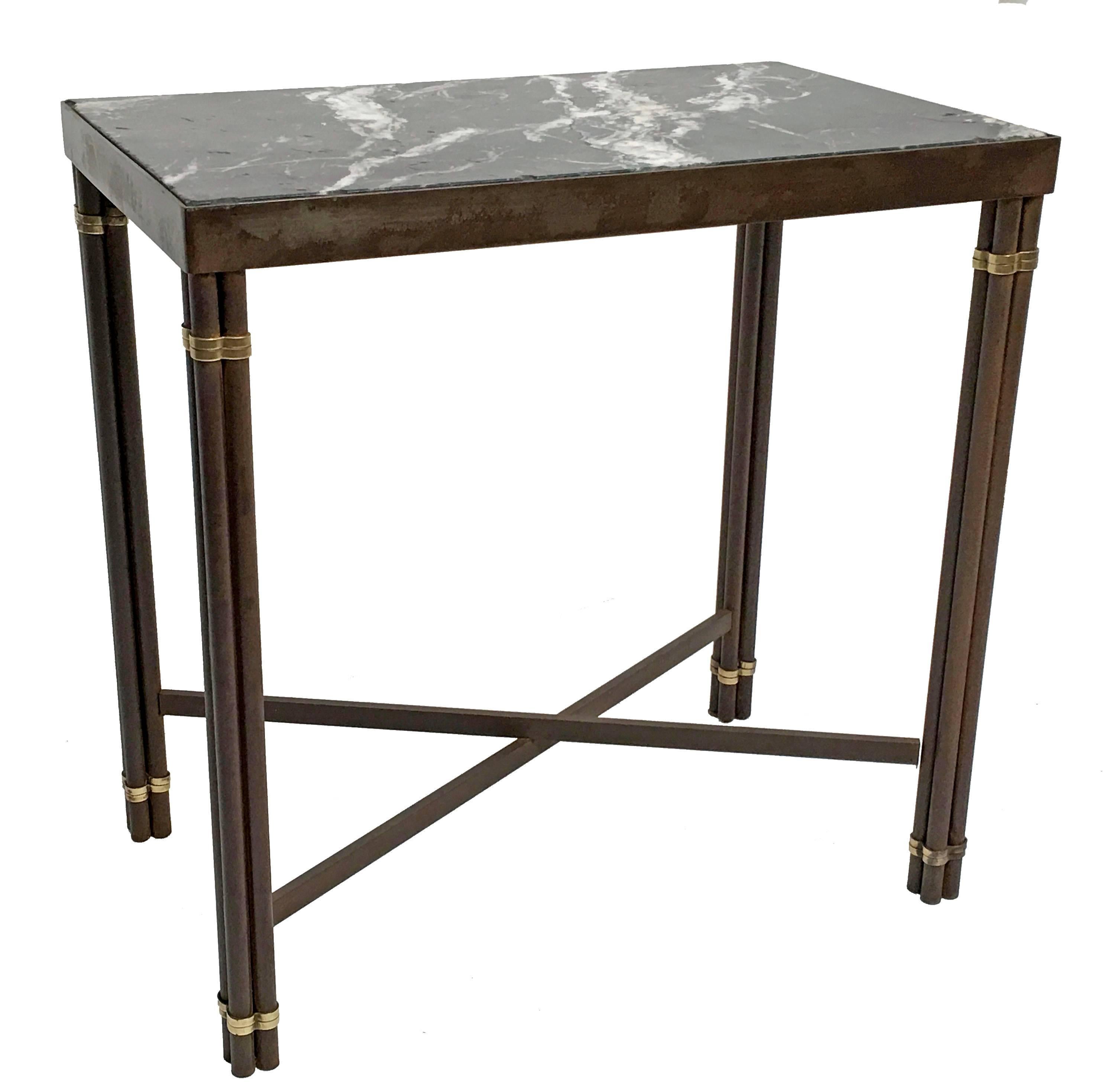 Rectangular iron and brass side table with inset Spanish Nero Marquina black marble top. The four iron rods tied with a brass band at the top and base with an X stretcher. Iron has been cleaned and polished. The marble-top has several minor chips