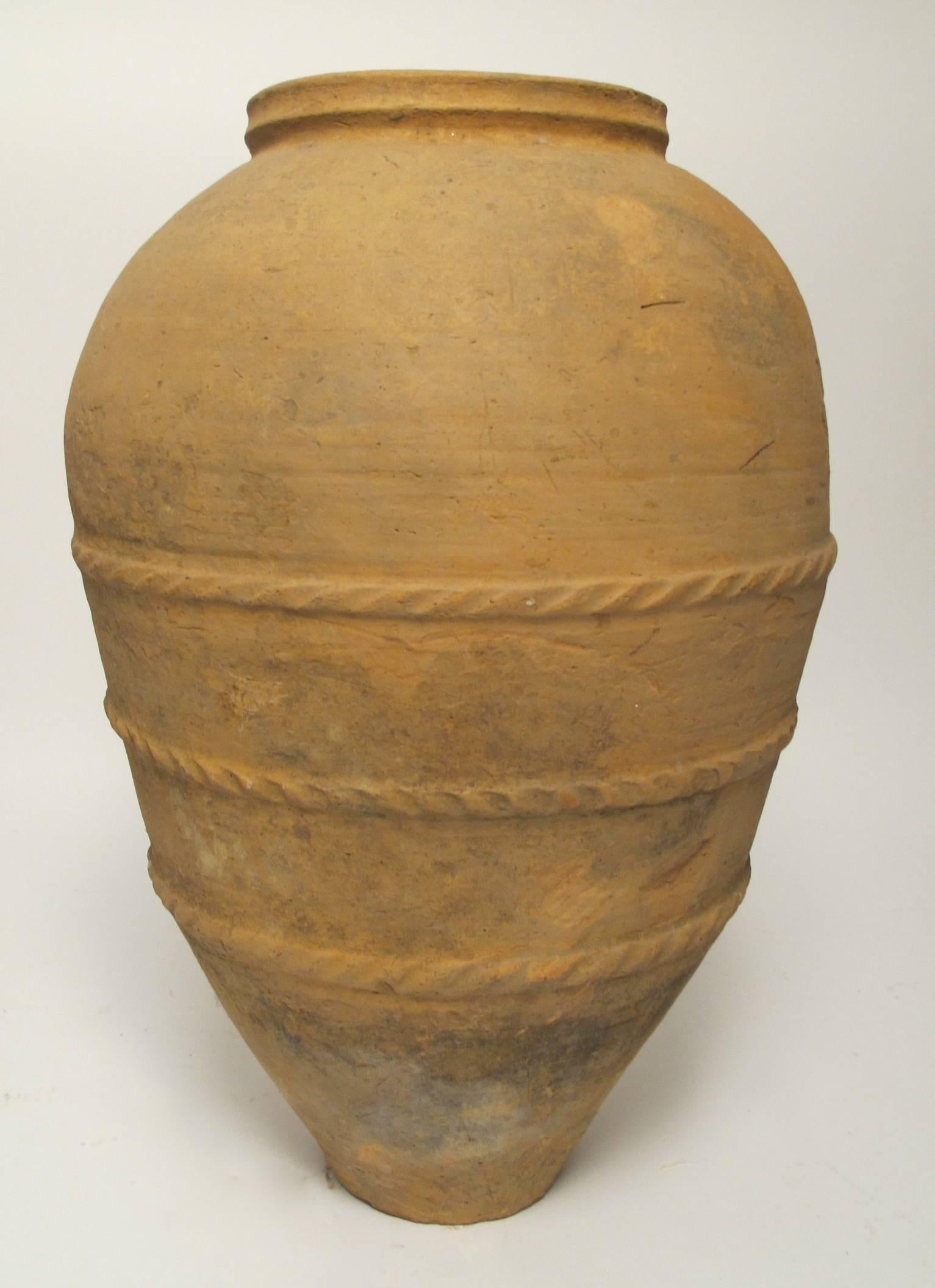 Terra Cotta Oil Jar with concave collar and three bands of twisted rope design around the mid section.  Greek, Mid to Late 19th. Century.
