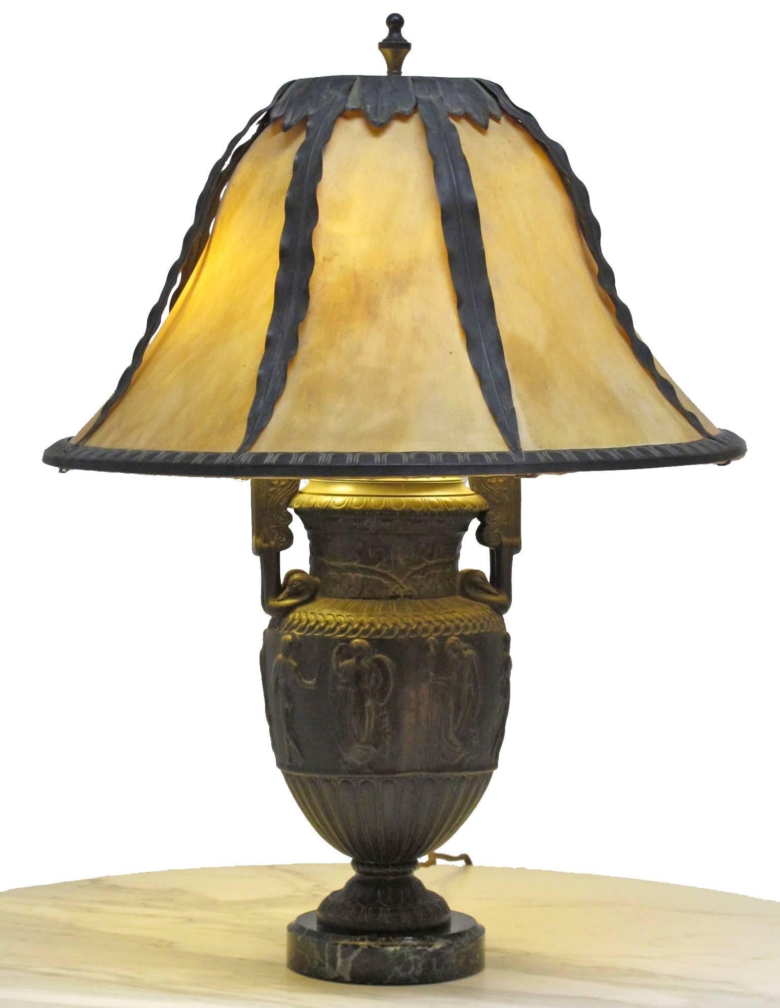 Neoclassical style repousse spelter urn on marble base with vellum shade. The 19th century urn was converted to a lamp in the early 20th century, the vellum shade having patinated copper trim and frame. Newly re-wired.