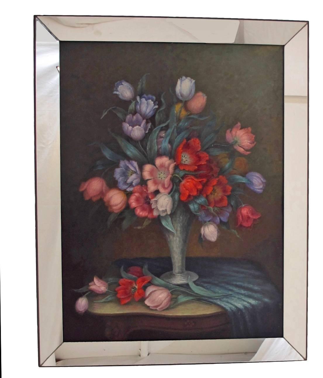 A finely painted large-scale colorful floral still life in mirrored frame. Oil on board, unsigned, American, circa 1940.