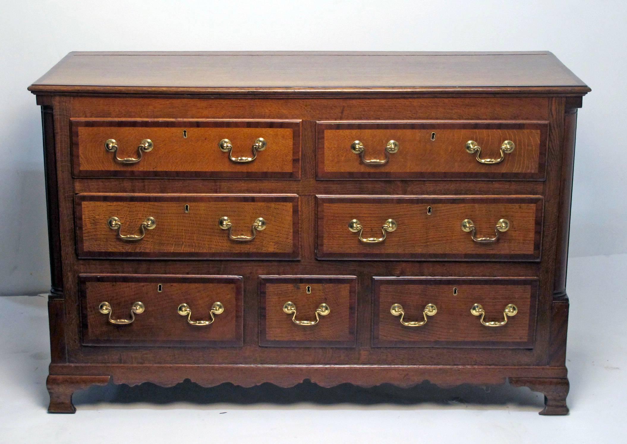 Antique English oak mule chest with mahogany trim and newer brass hardware. Altered and converted to a buffet. Recently refinished, England, mid-18th century.