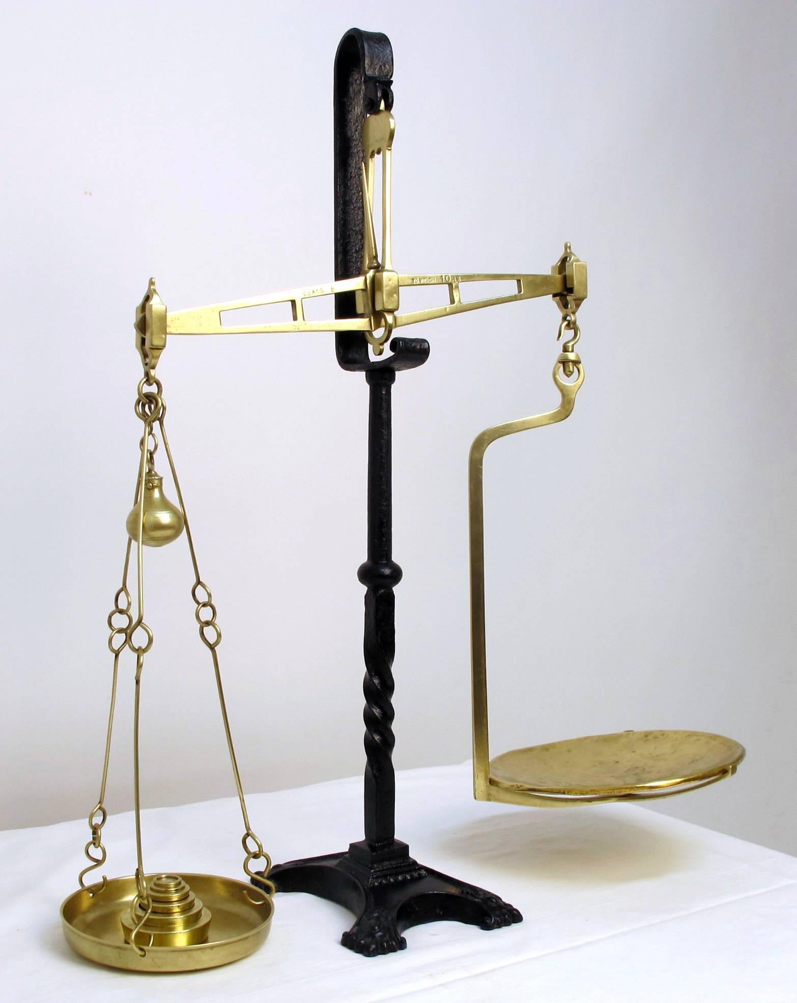 A large antique scale. Cast and wrought iron base with brass balance and weights. European (probably French), late 18th-early 19th century.