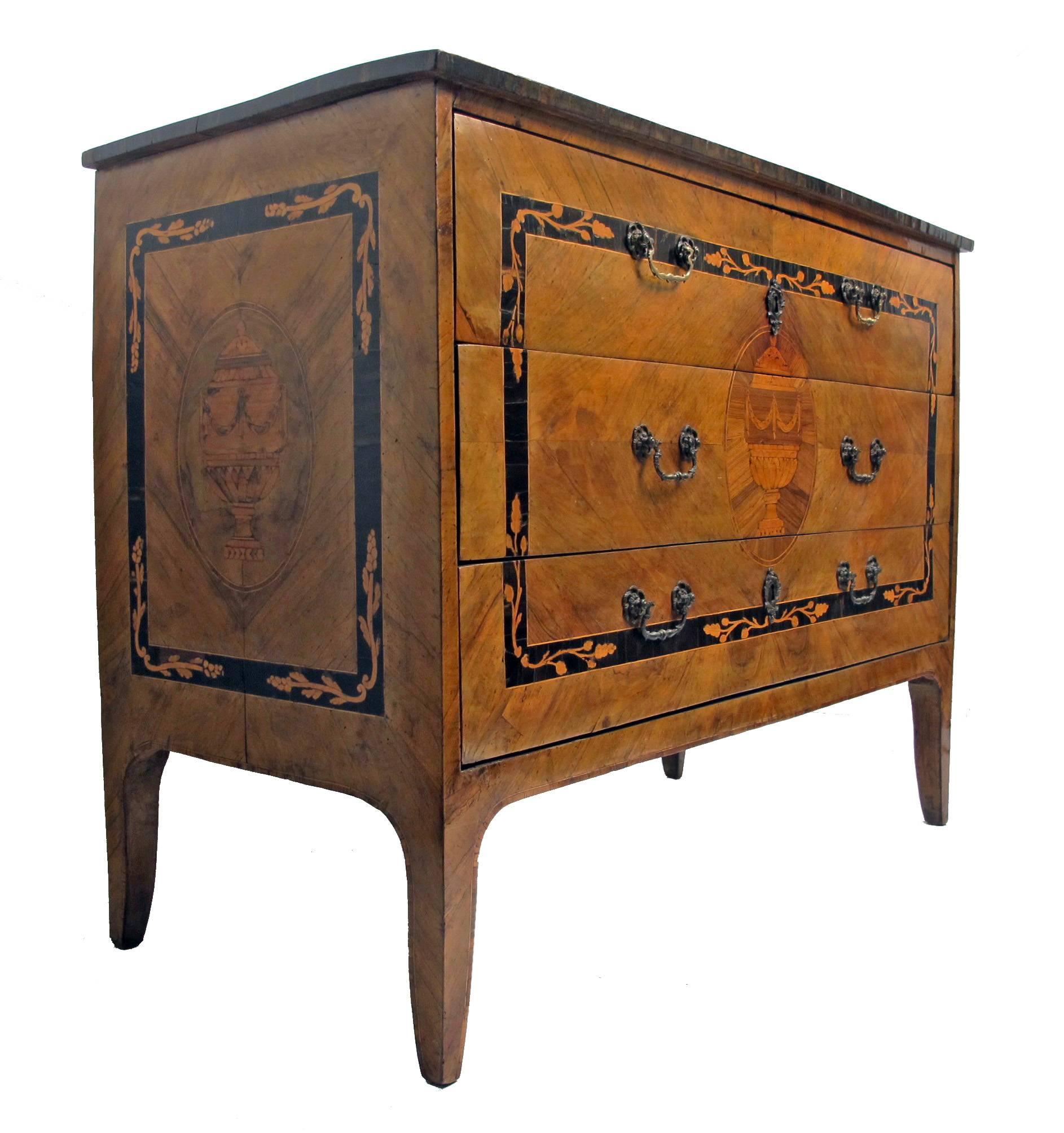 Three drawer walnut commode embellished with exquisite inlaid marquetry design of neoclassical motifs. In remarkable original antique condition with beautiful patina (pulls have been replaced), Italy, 18th century.
