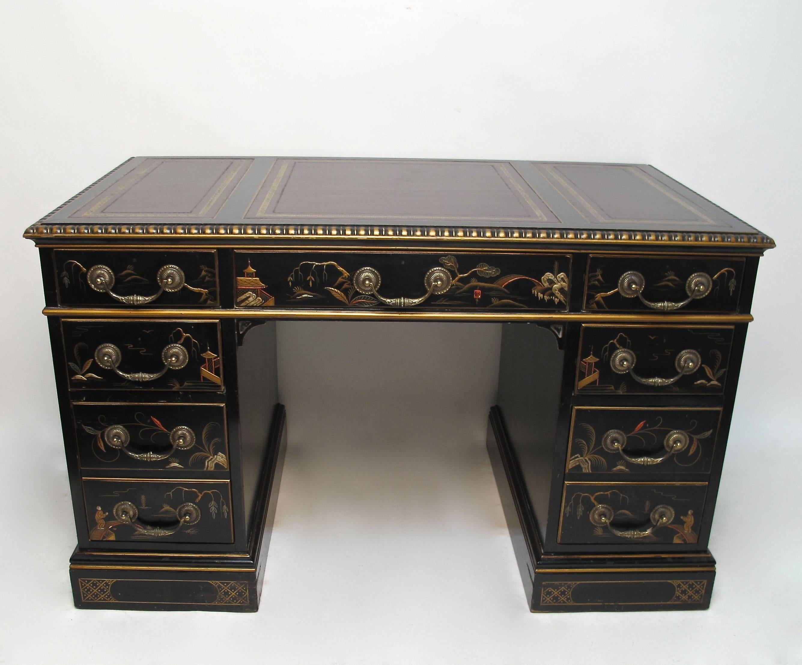 Chinoiserie Decorated Double Pedestal Desk with Gilt Tooled Red Leather Top.  Black ground hand painted with figures, flowers and garden scenes.  The top with three inset red leather panels each with gold tooling.  Each pedestal with with two short