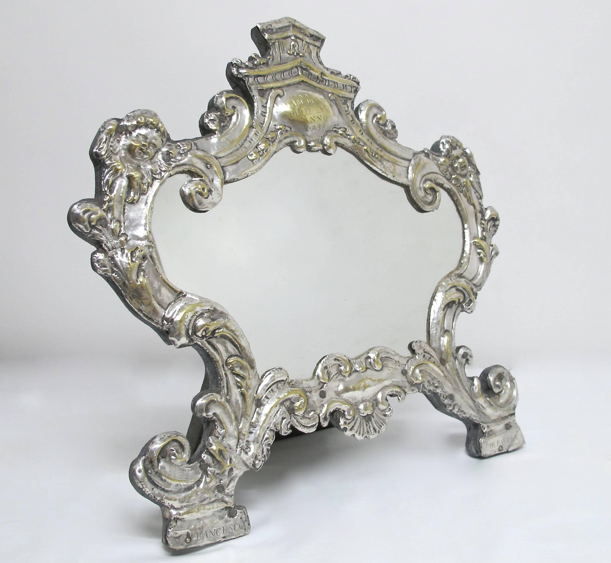 Beautiful old silver on brass frame. Originally a memento mori and would have held written information honoring a loved one who had passed. There is an engraved name (Elam DF Cavall, Delle LVM, ANNO 1738) at the top of the frame.On either leg reads