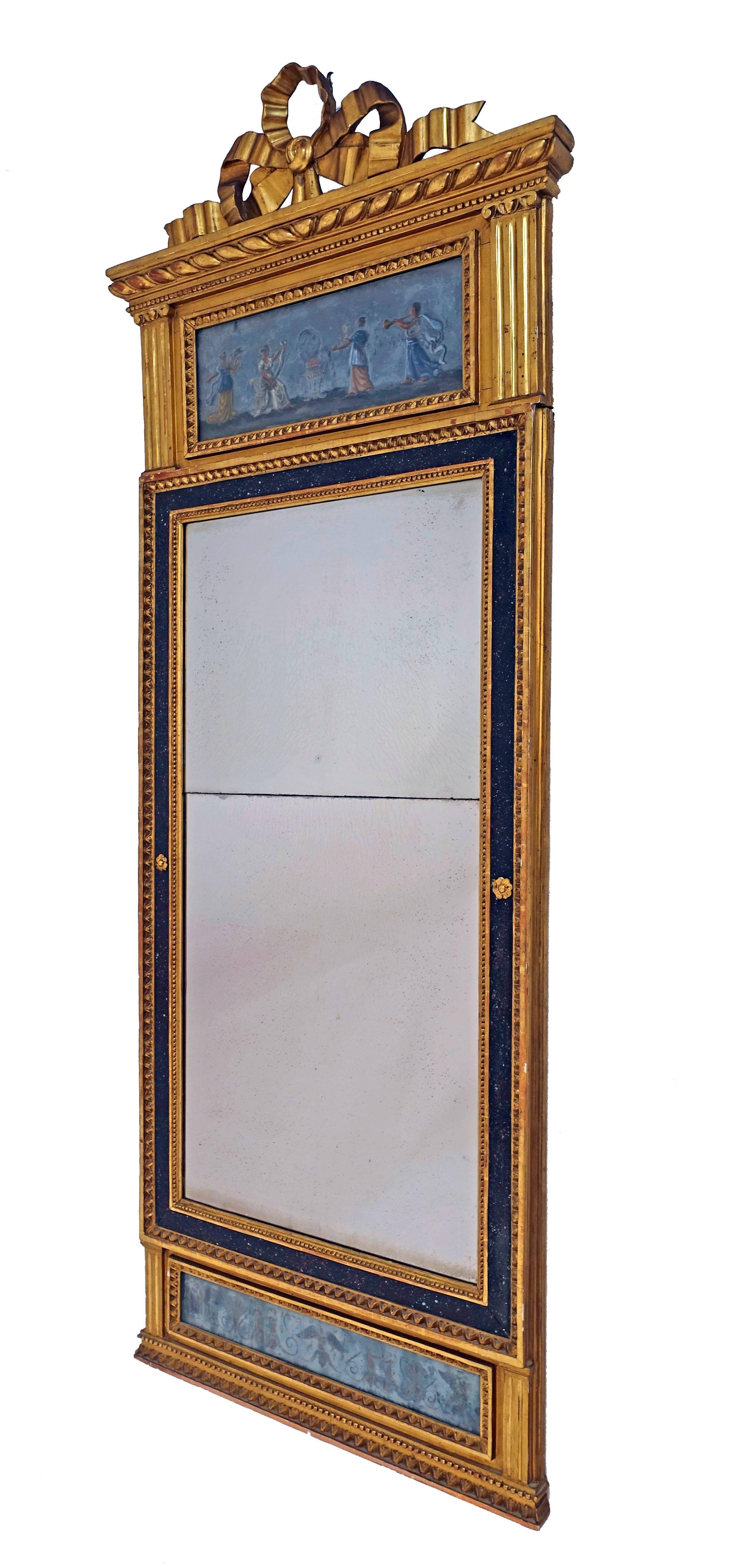 Neoclassical carved and giltwood frame with églomisé ‘reverse hand-painted glass panels’ at the top, bottom and surrounding periphery, and having original period mirror. In beautiful original condition. France, late 18th-early 19th century.